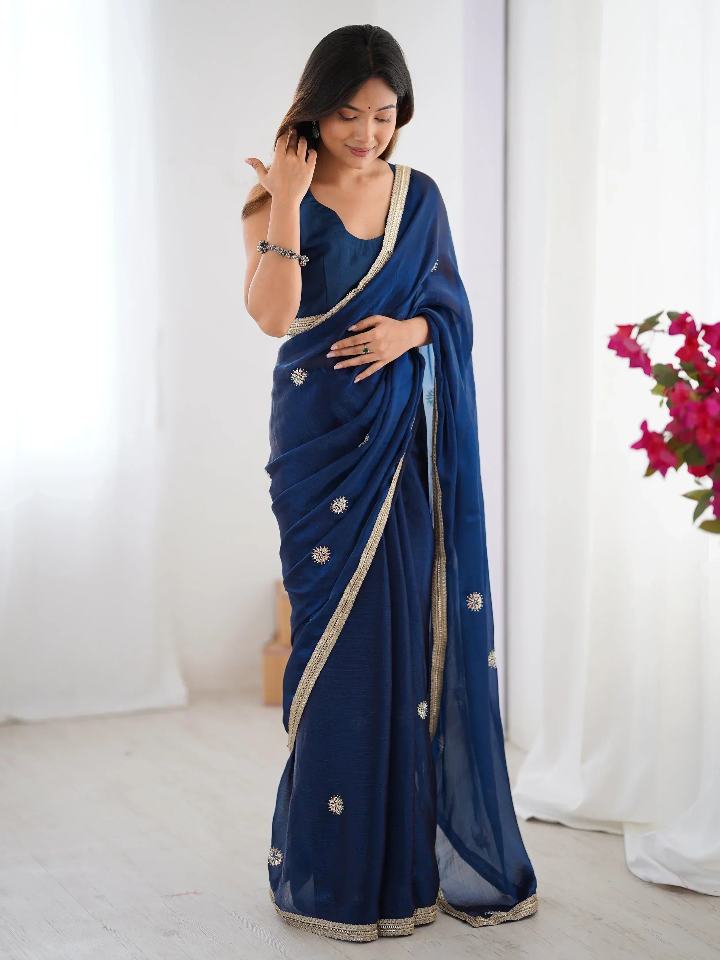 Elegant navy blue saree with gold embroidery and floral motifs, perfect for Indian ethnic wear occasions.