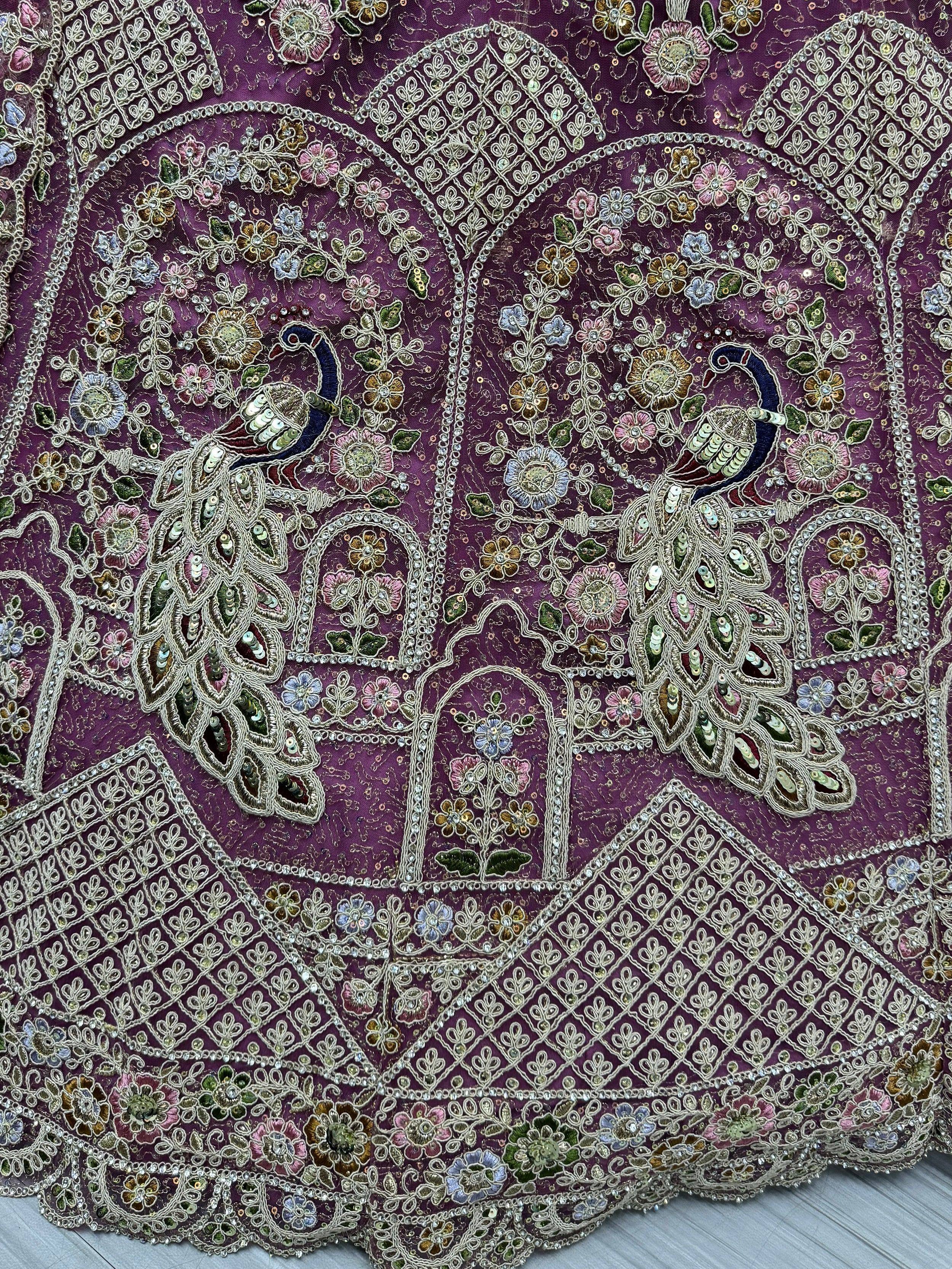 Purple ethnic lehenga with peacock embroidery, floral motifs, and sequin detailing for Indian weddings