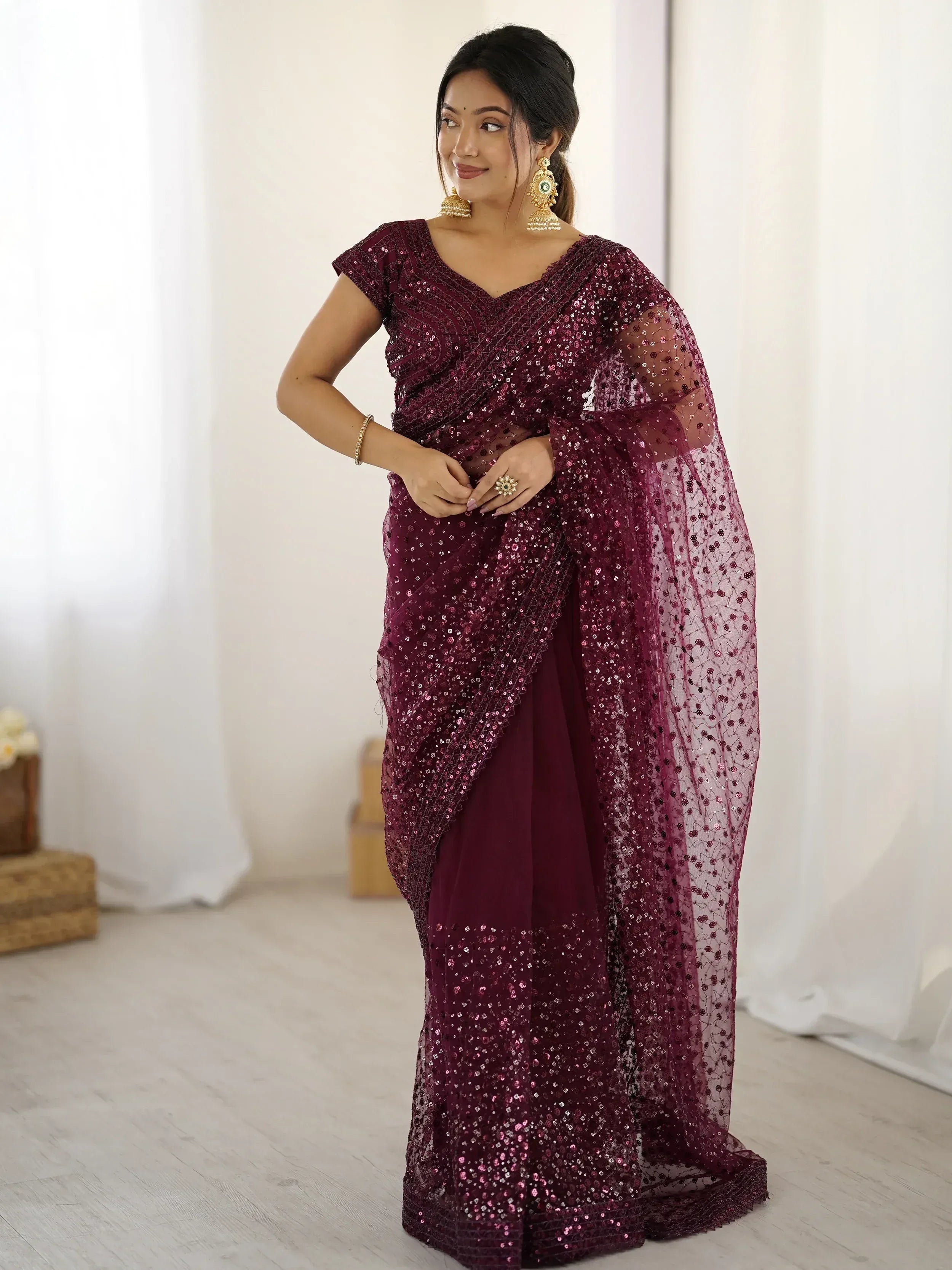 Burgundy sequin saree with sheer overlay, perfect for Indian ethnic occasions and festive events.