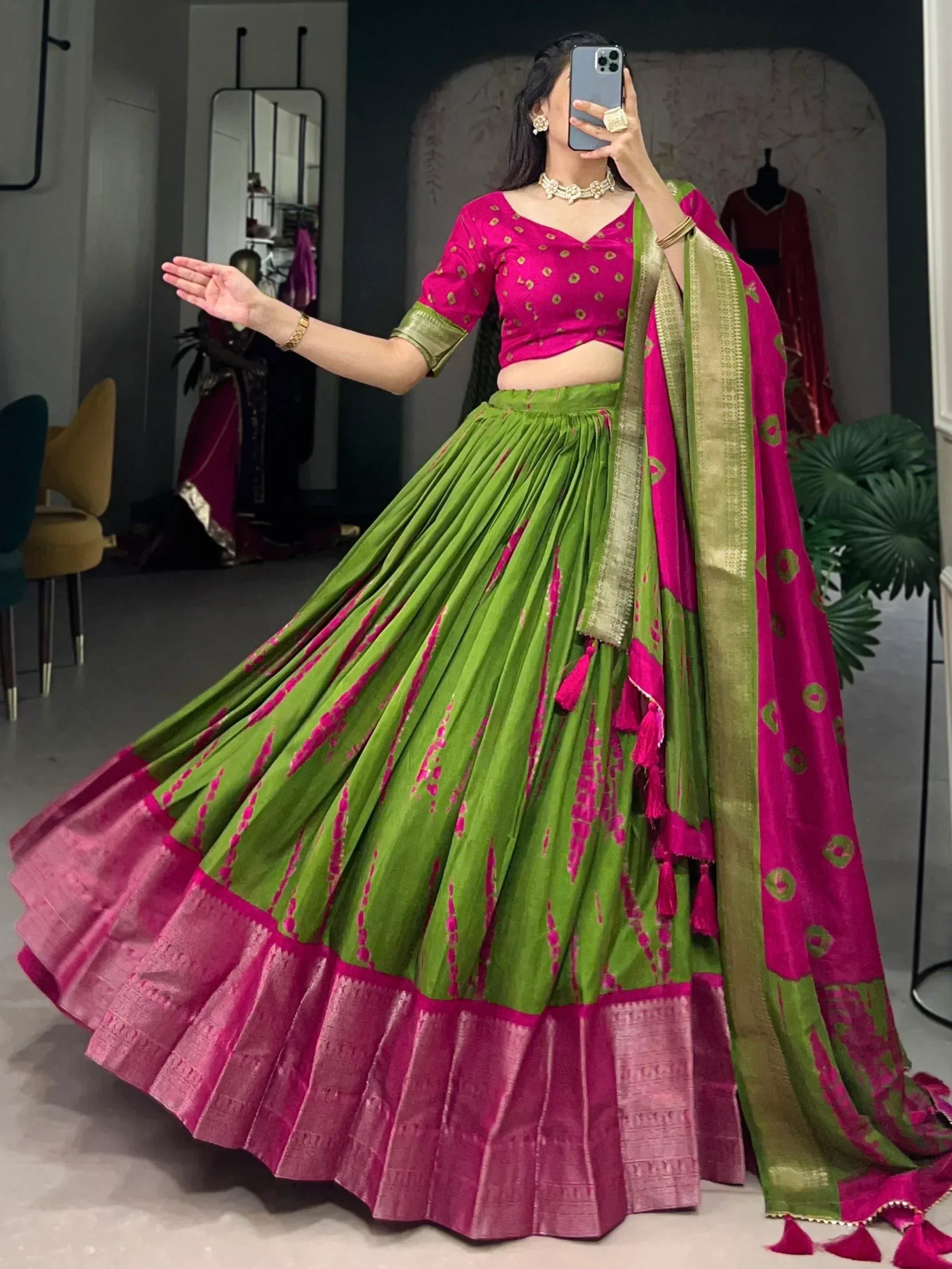 Vibrant pink and green lehenga choli with gold embroidery, perfect for Indian ethnic wear occasions.