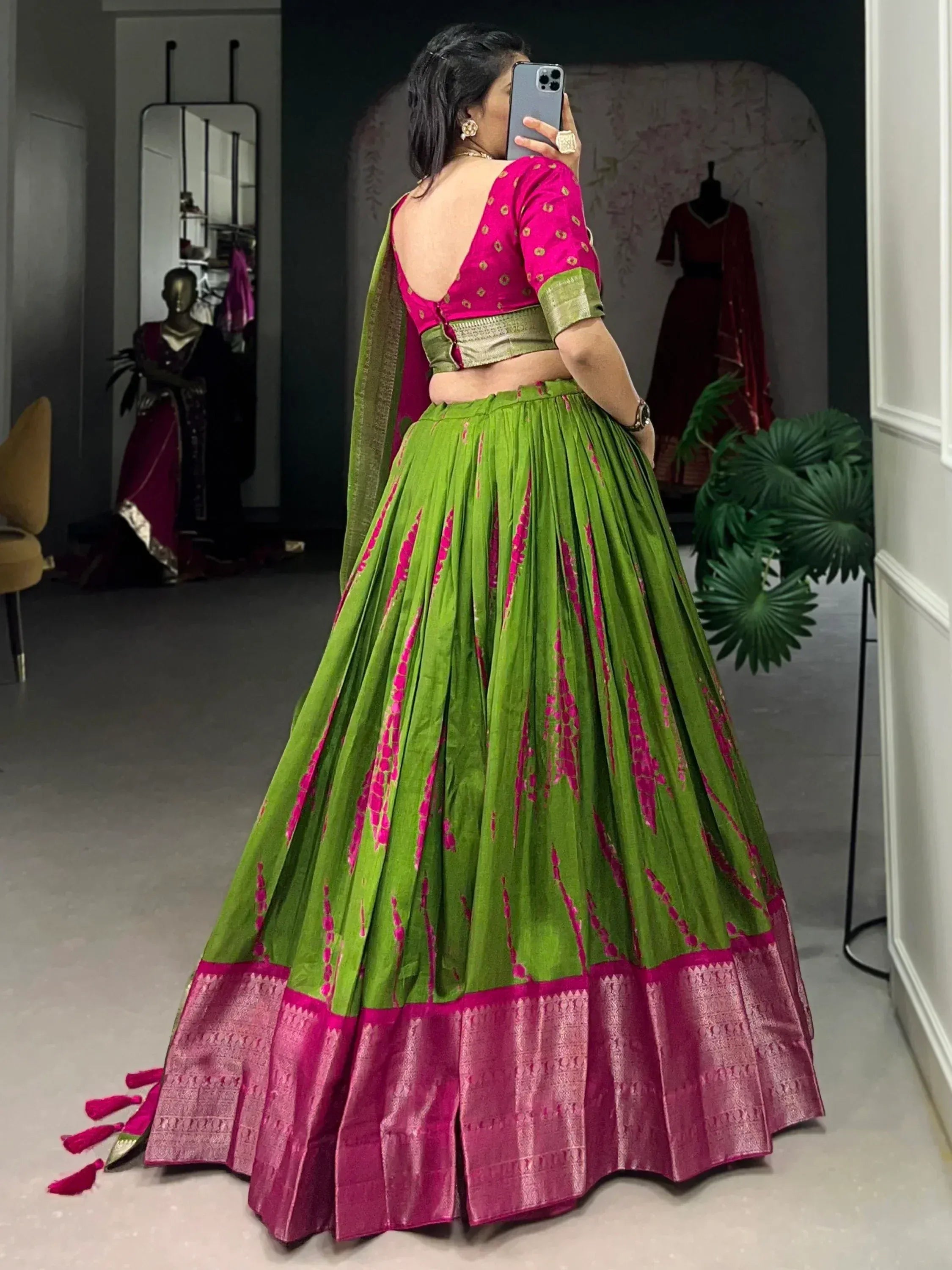 Green and pink designer lehenga choli with backless blouse, perfect for Indian ethnic wear occasions.