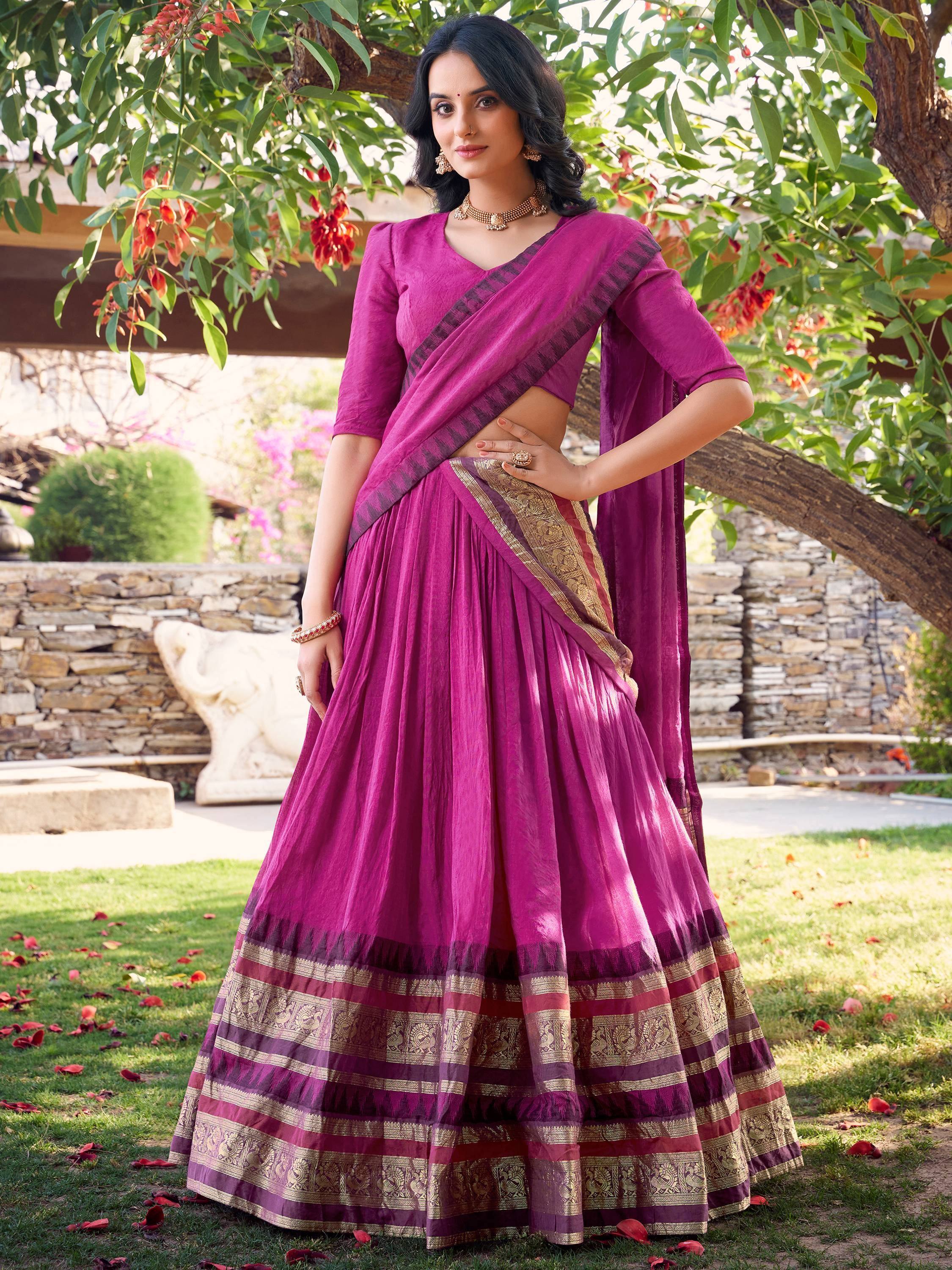 Woman in vibrant purple lehenga choli with gold border, perfect for Indian ethnic occasions