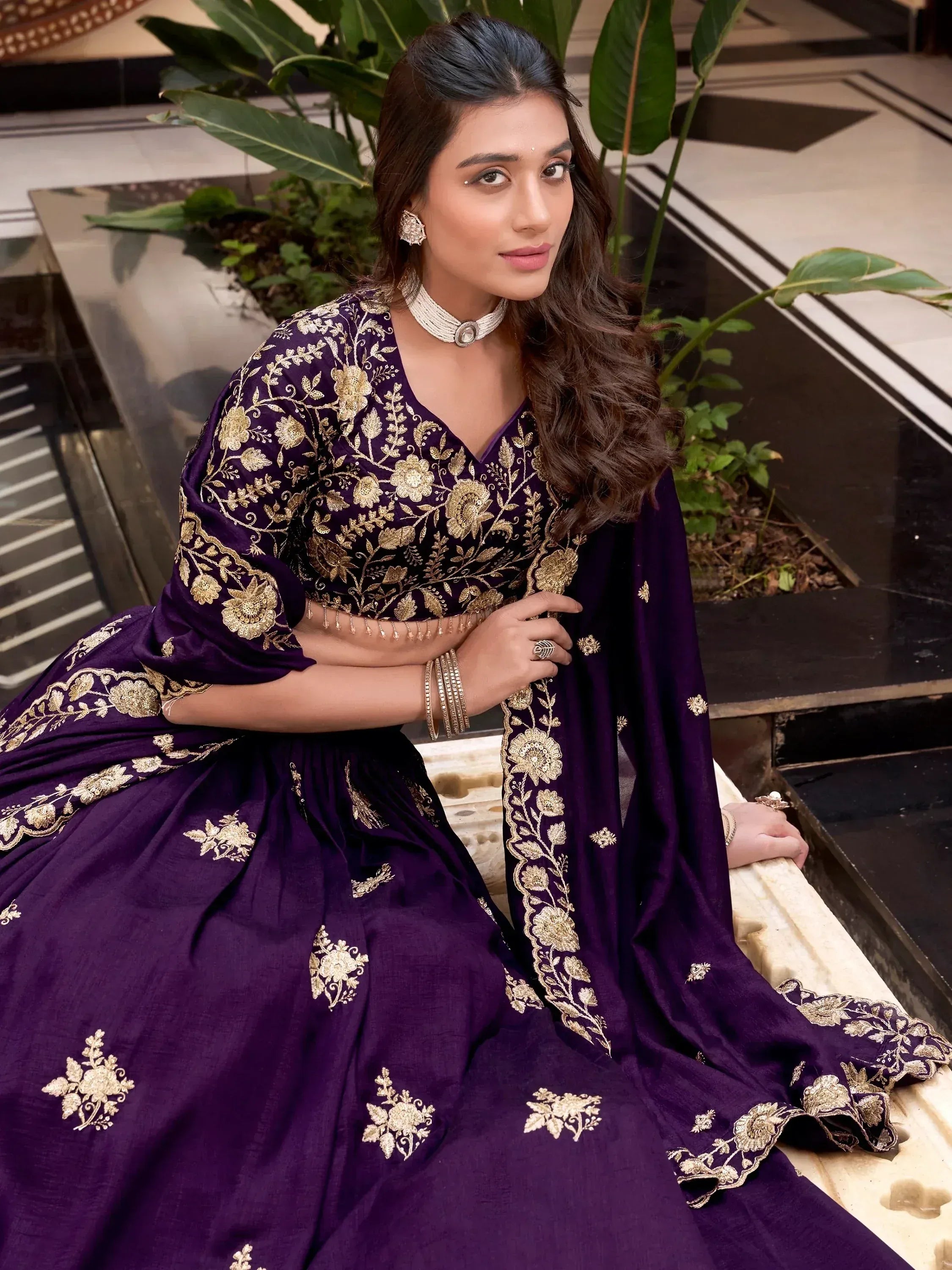 Purple lehenga choli with gold floral embroidery, perfect for Indian ethnic wear occasions.