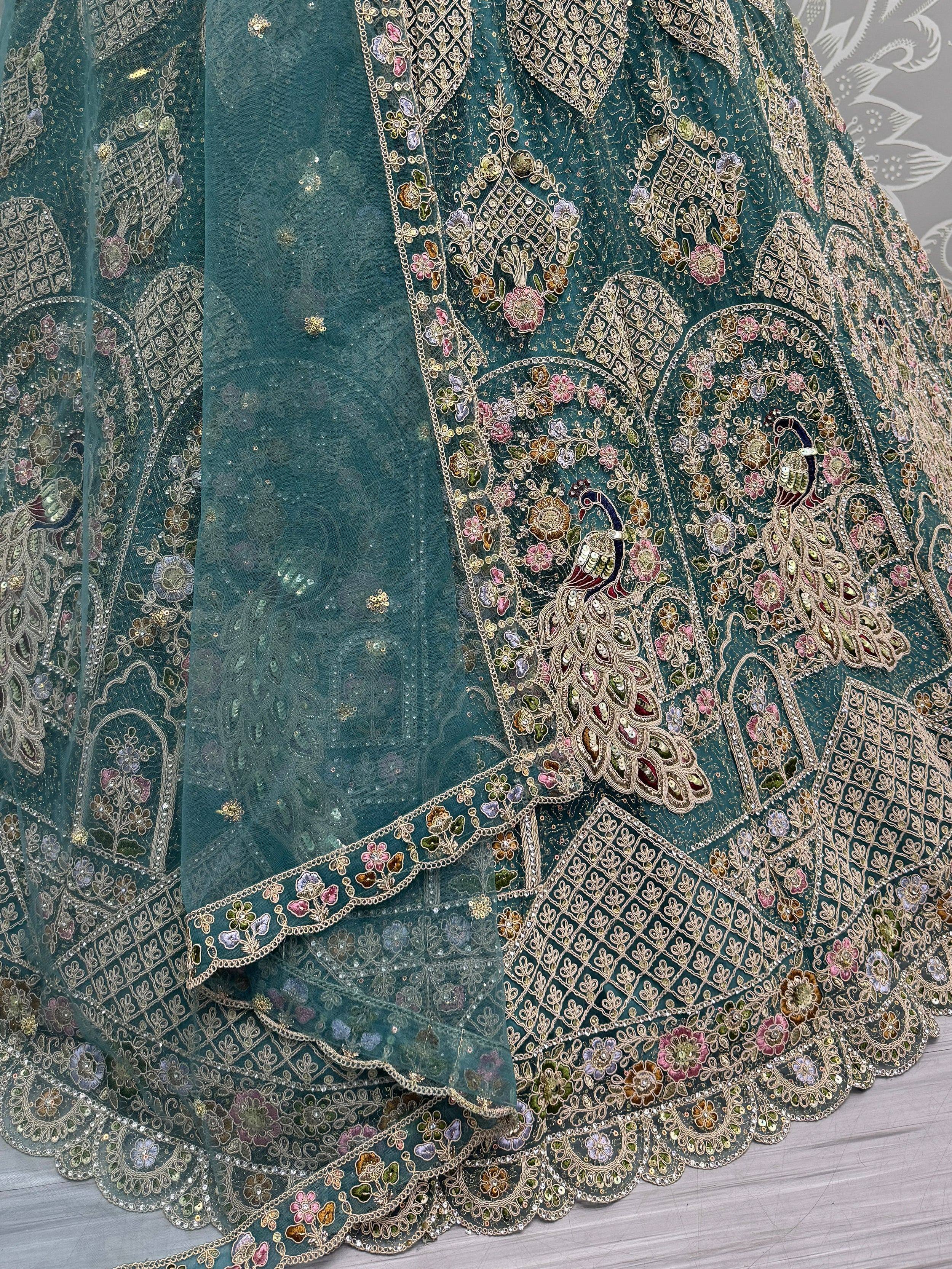 Teal designer lehenga with intricate floral and peacock embroidery, perfect for Indian ethnic wear.