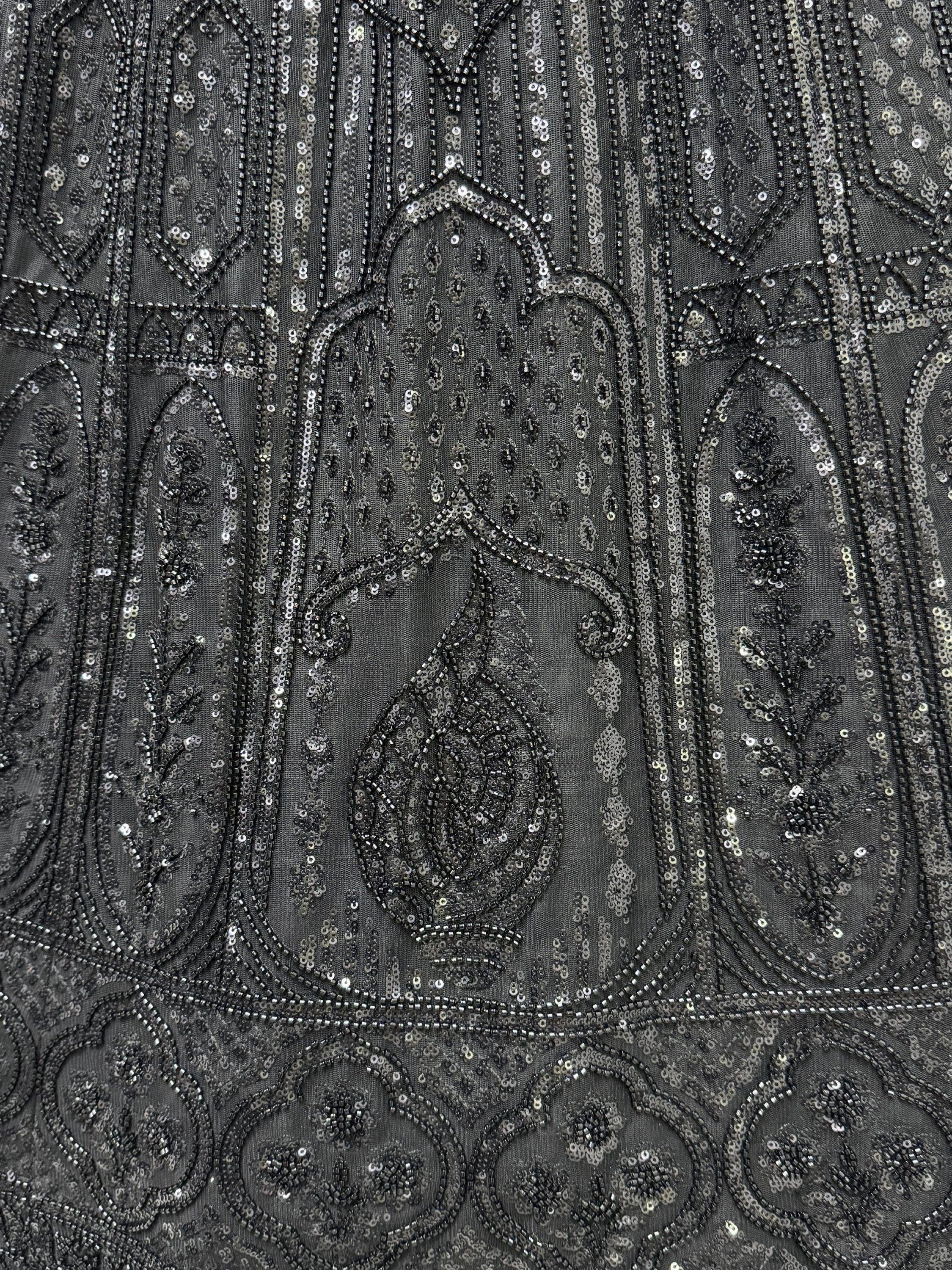 Black ethnic wear with intricate sequin and bead embroidery, perfect for festive occasions.