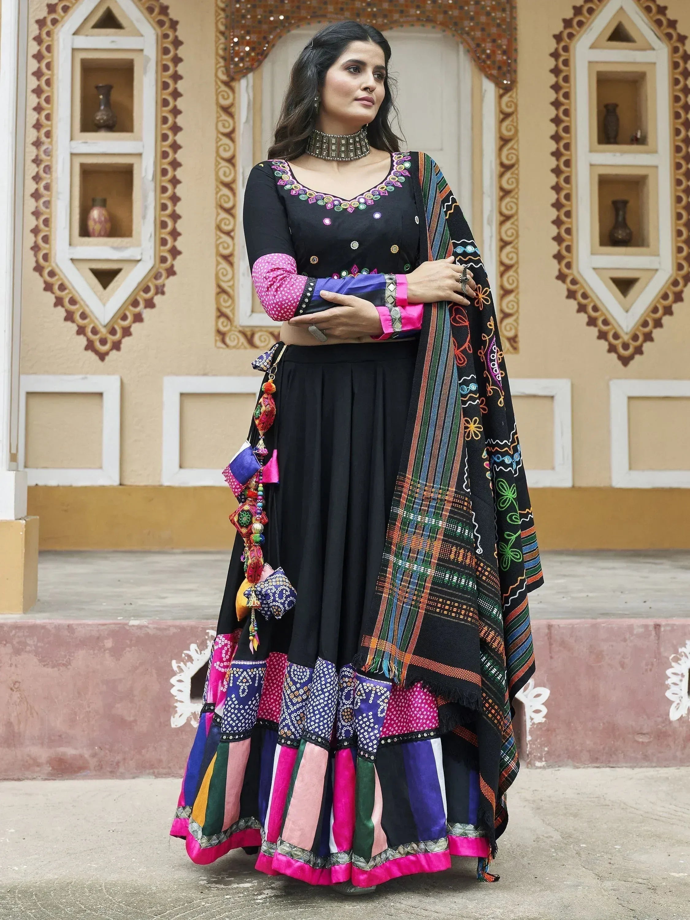 Black embroidered ethnic sharara set with colorful patchwork and dupatta, perfect for Indian festive occasions