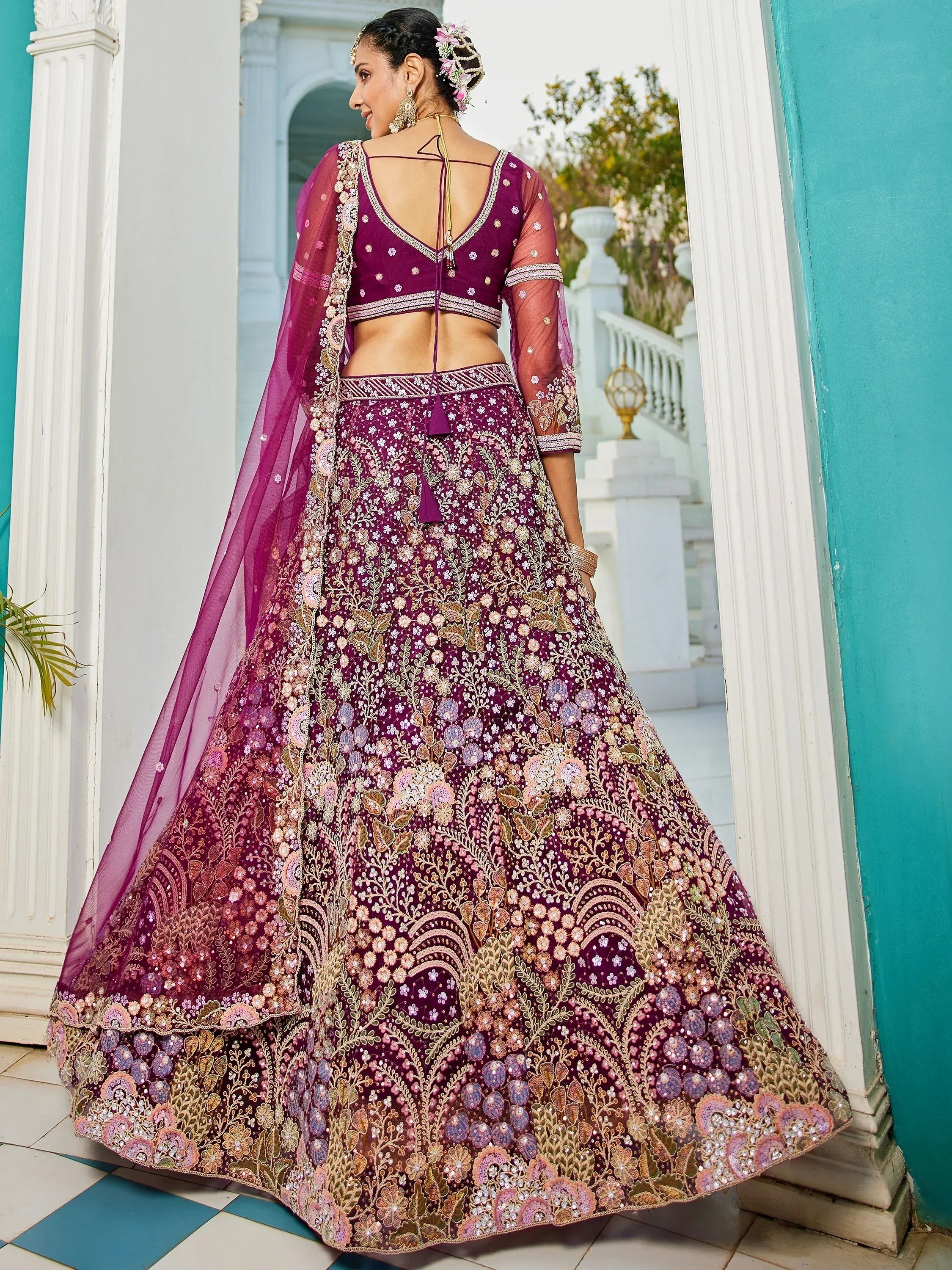 Elegant purple lehenga choli with floral embroidery and sheer dupatta, perfect for Indian weddings and festive occasions.