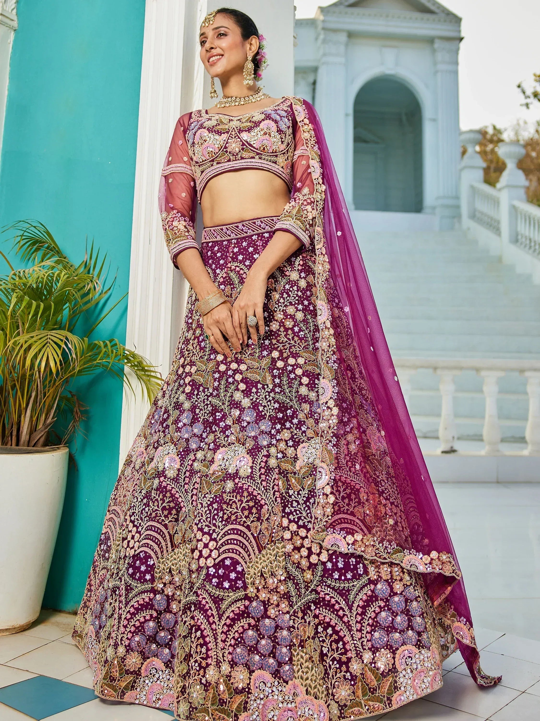 Elegant purple embroidered lehenga choli with floral motifs, perfect for Indian weddings and festive occasions.