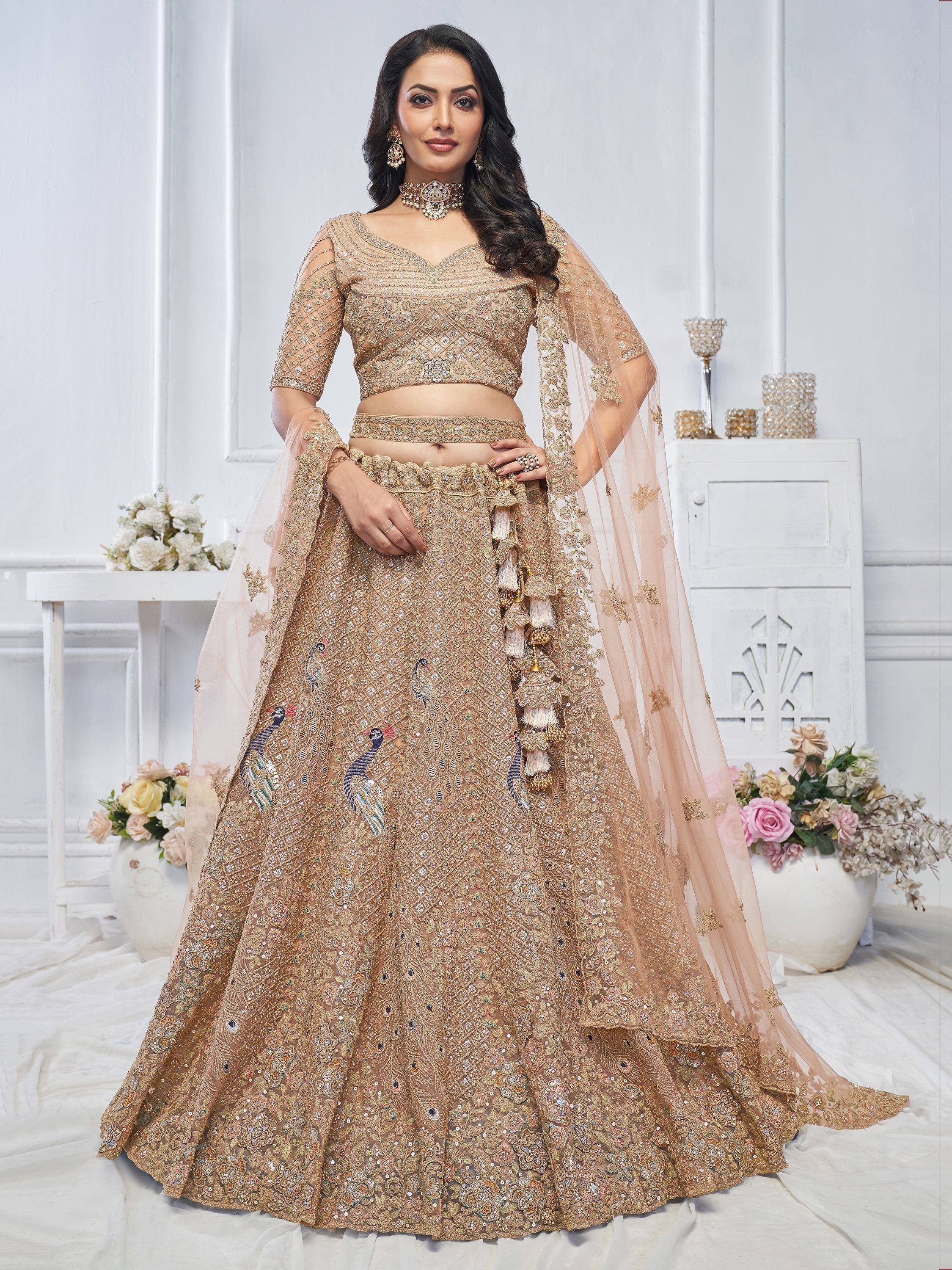 Elegant gold lehenga choli with peacock embroidery and tassels, perfect for Indian weddings and festive occasions.