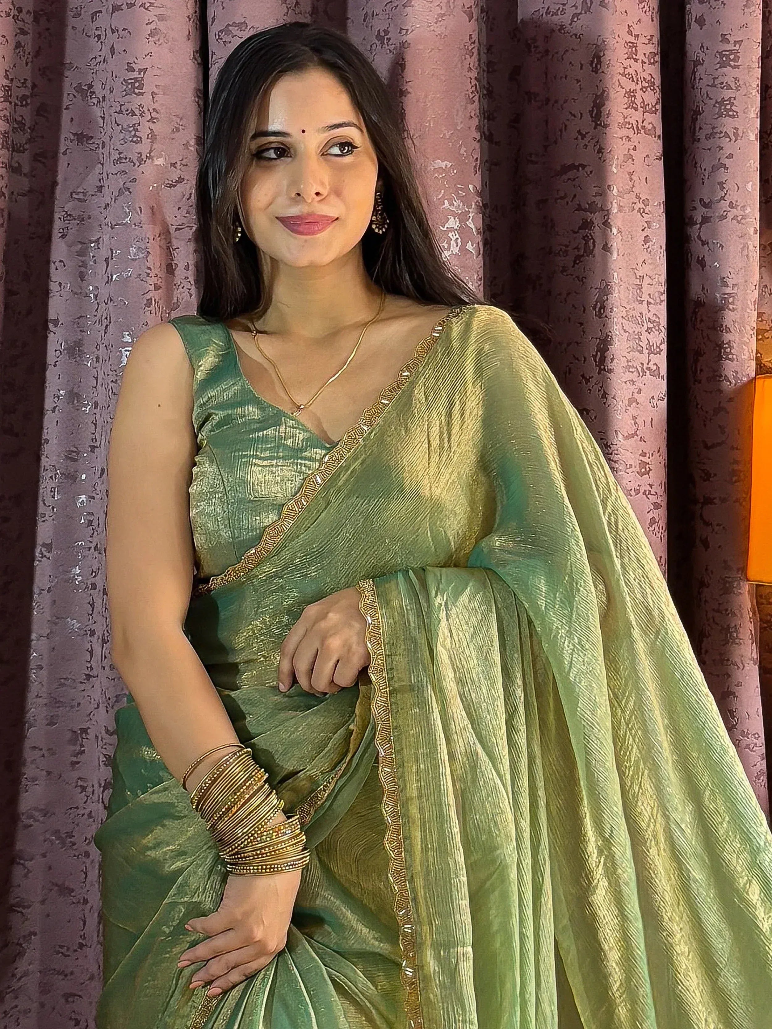 Woman in green designer saree with gold border, ethnic wear for festive occasions