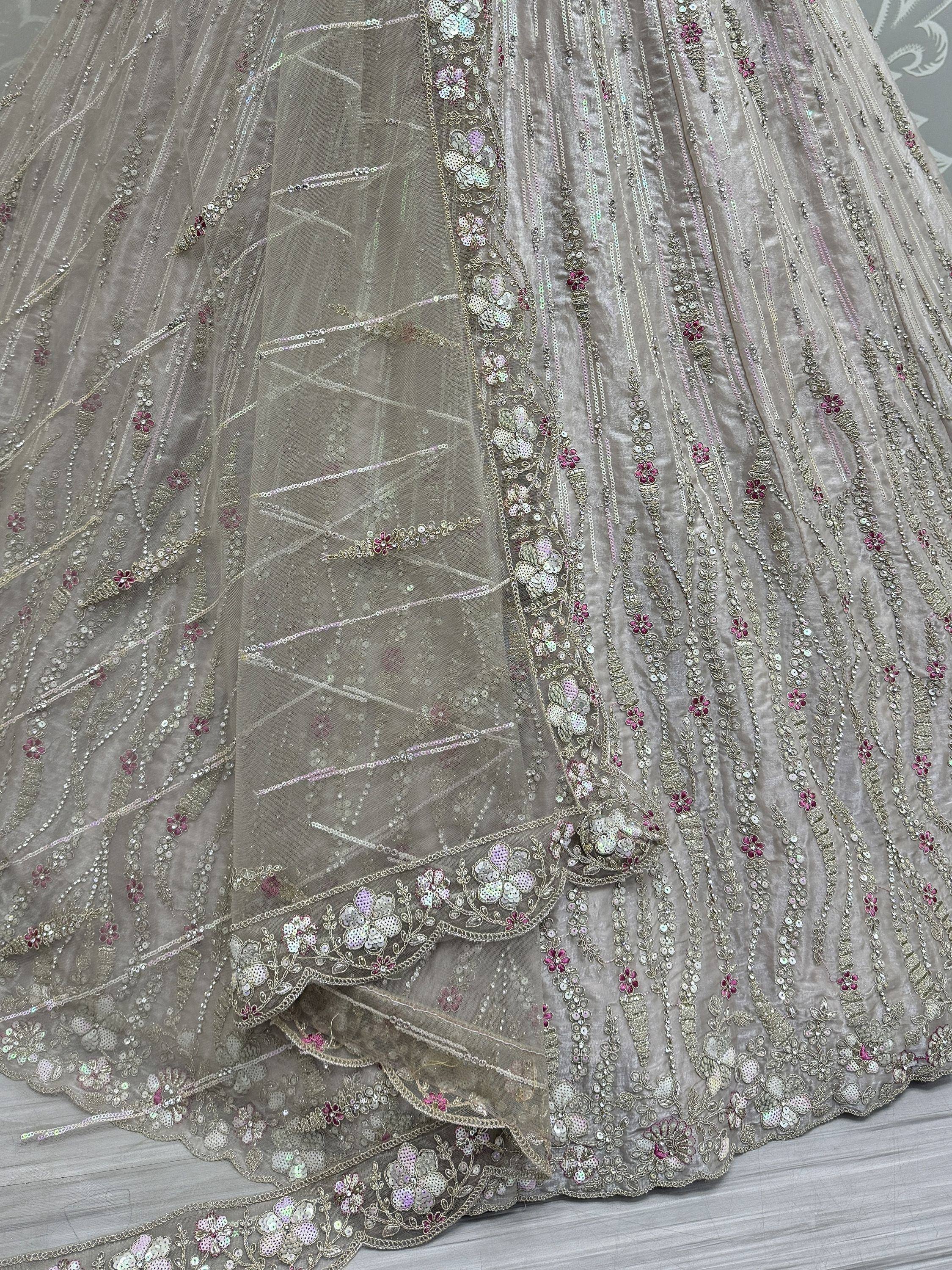 Elegant grey lehenga with floral sequin embroidery and sheer net overlay, perfect for Indian ethnic wear.