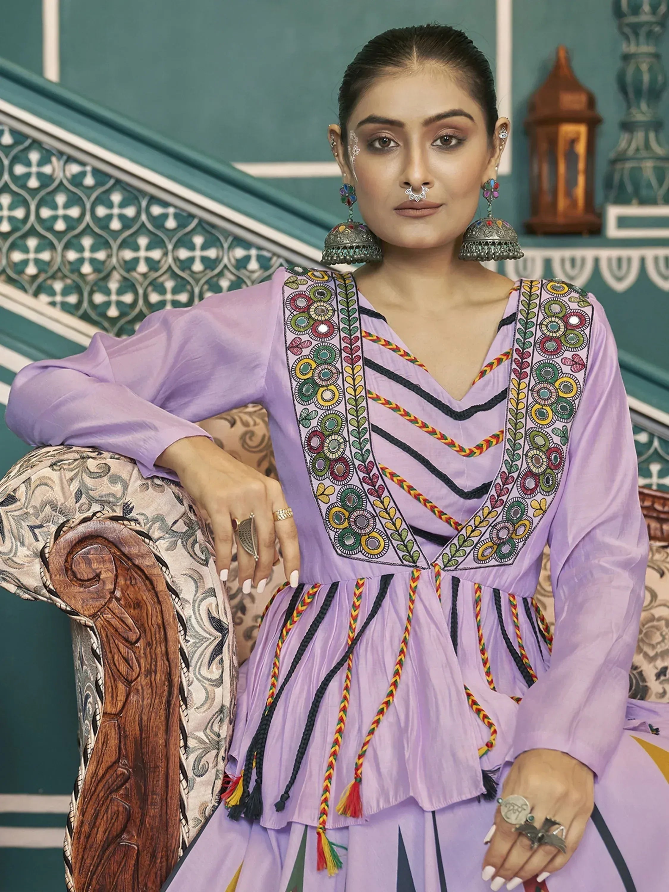 Purple embroidered ethnic gown with colorful tassels and traditional jewelry