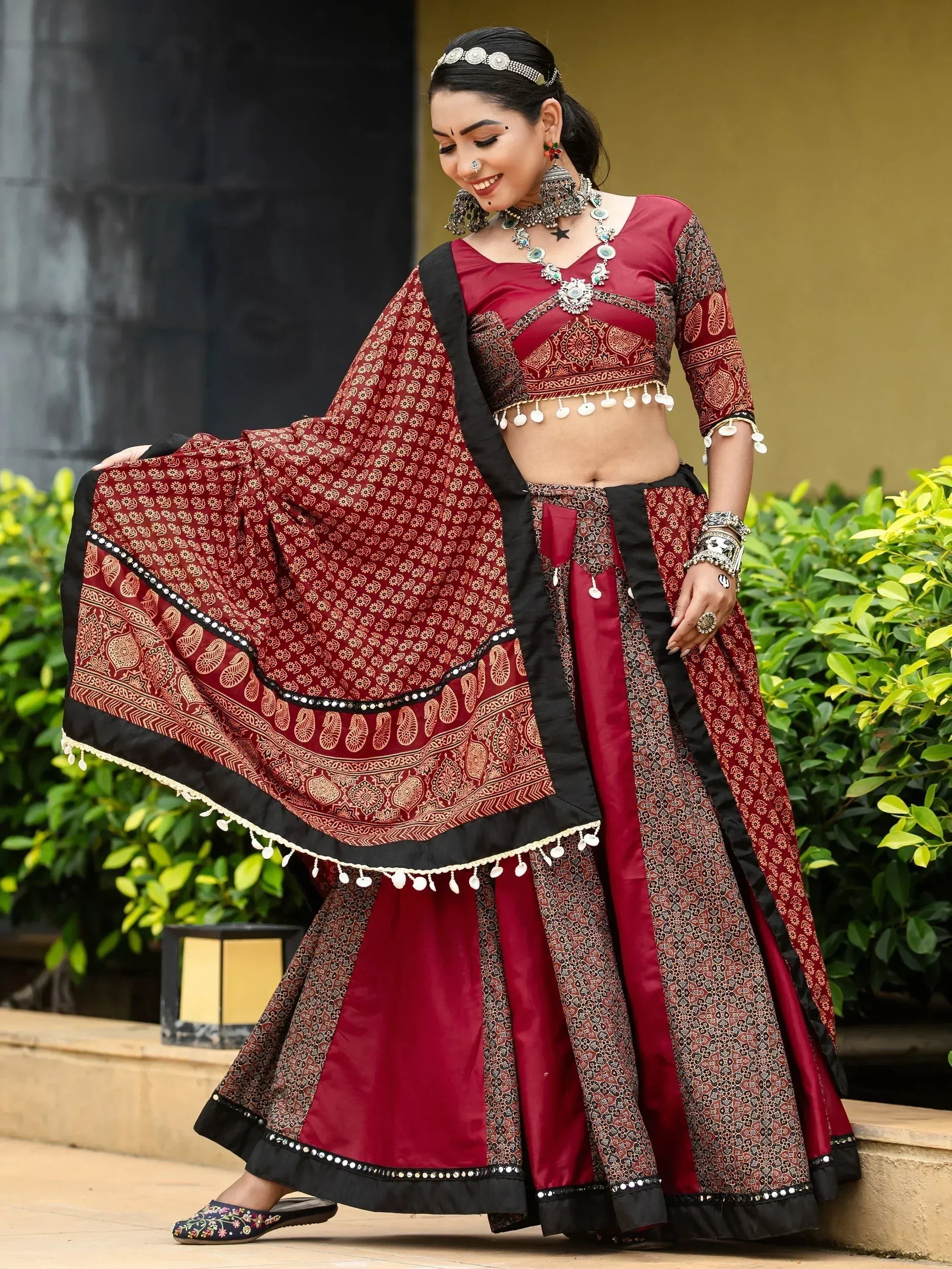 Maroon and black printed lehenga choli with mirror work, perfect for Indian ethnic wear and festive occasions.