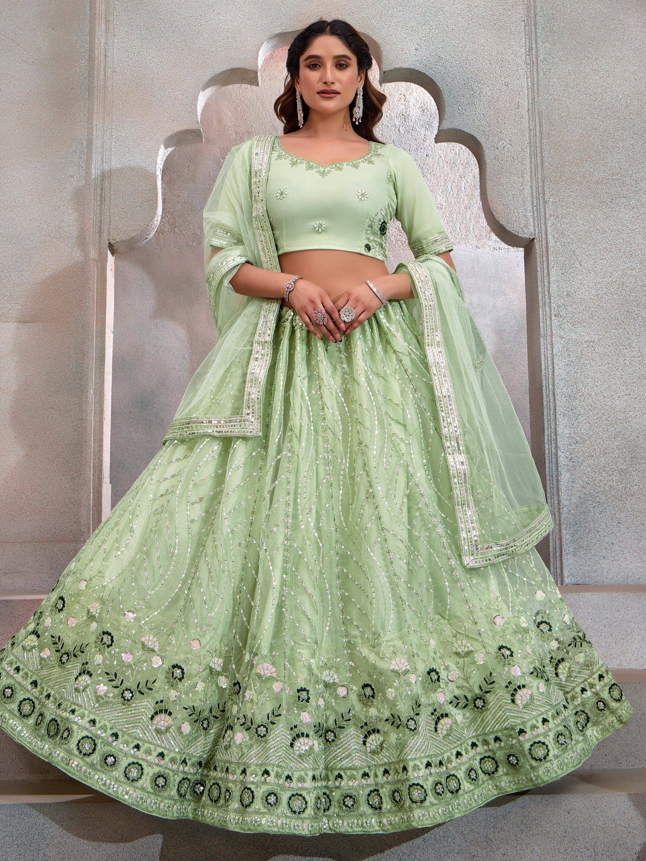 Mint green designer lehenga choli with floral embroidery and sequin work, perfect for Indian weddings and festive occasions.