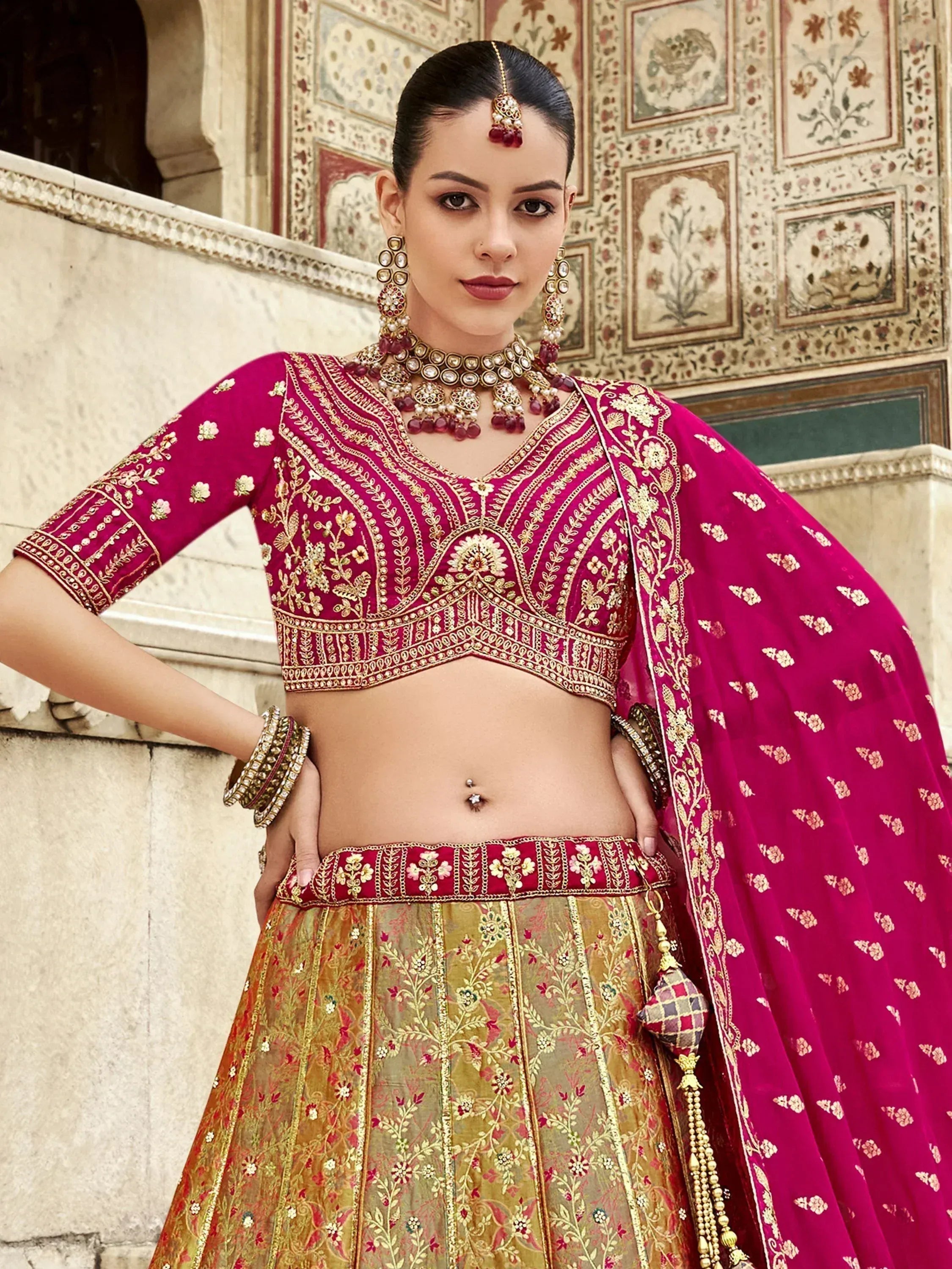 Fuchsia and gold embroidered lehenga choli with matching dupatta, traditional Indian ethnic wear for weddings