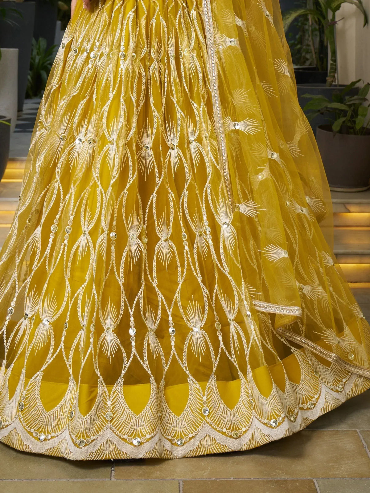 Mustard yellow lehenga with intricate white embroidery and sequin detailing, perfect for Indian ethnic wear.