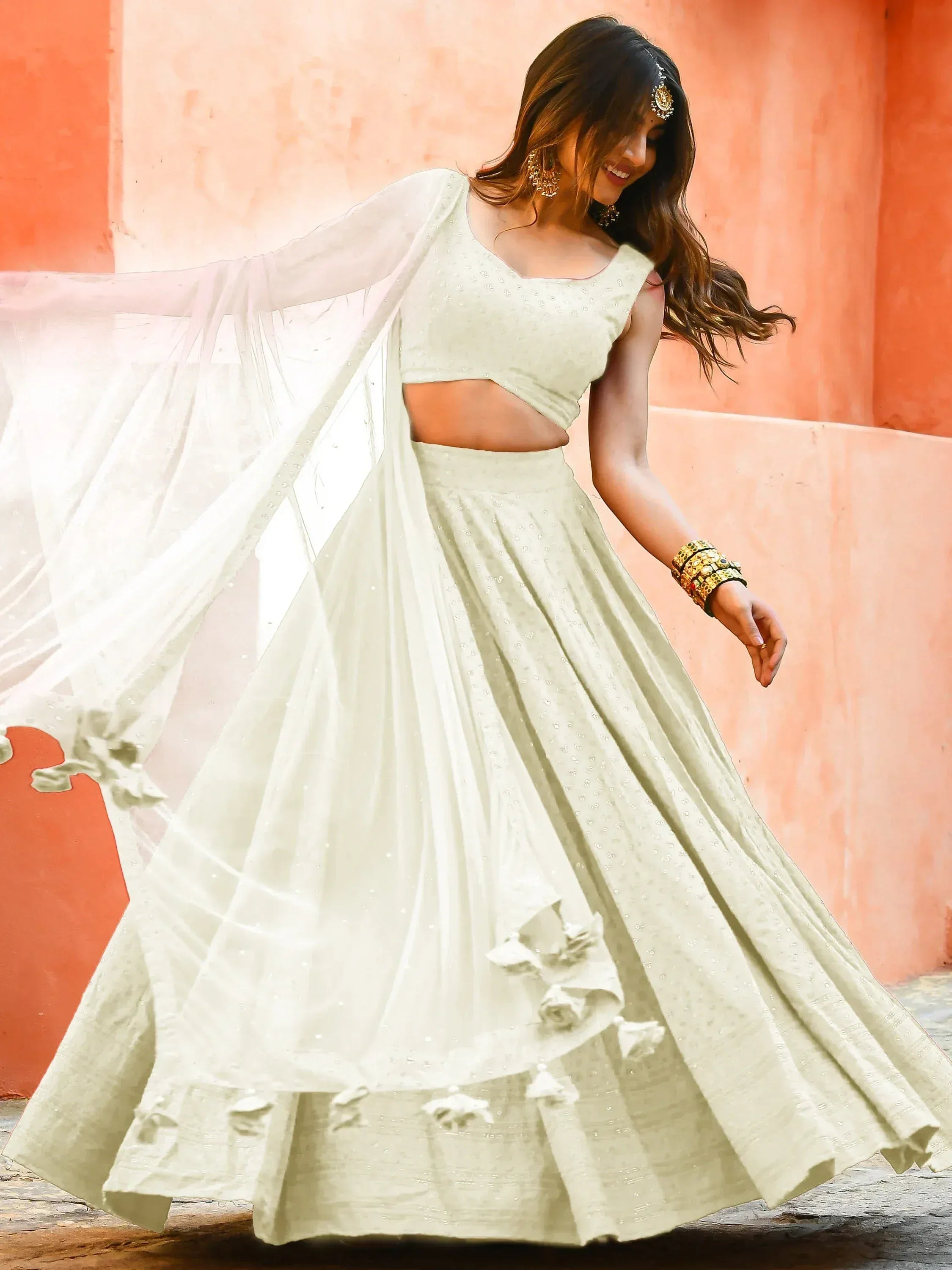 Elegant off-white lehenga choli with floral details and sheer dupatta, perfect for Indian ethnic occasions