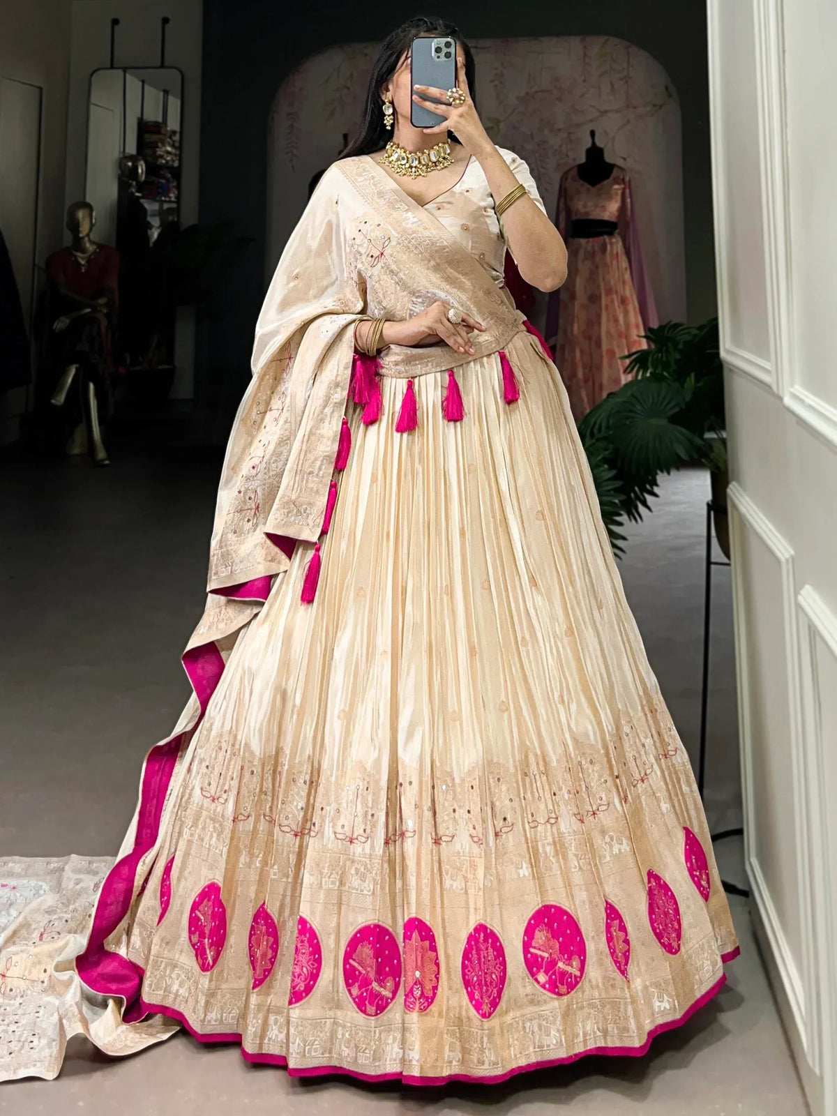 Cream and pink embroidered lehenga choli with tassels, perfect for Indian ethnic wear occasions