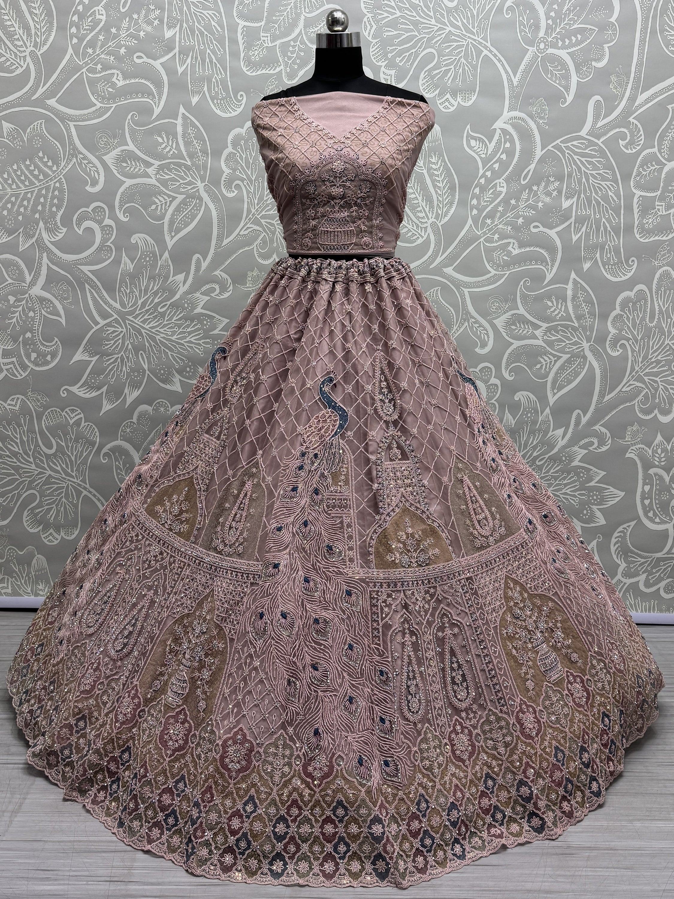 Elegant dusty pink lehenga choli with peacock embroidery and intricate net work, perfect for Indian weddings.