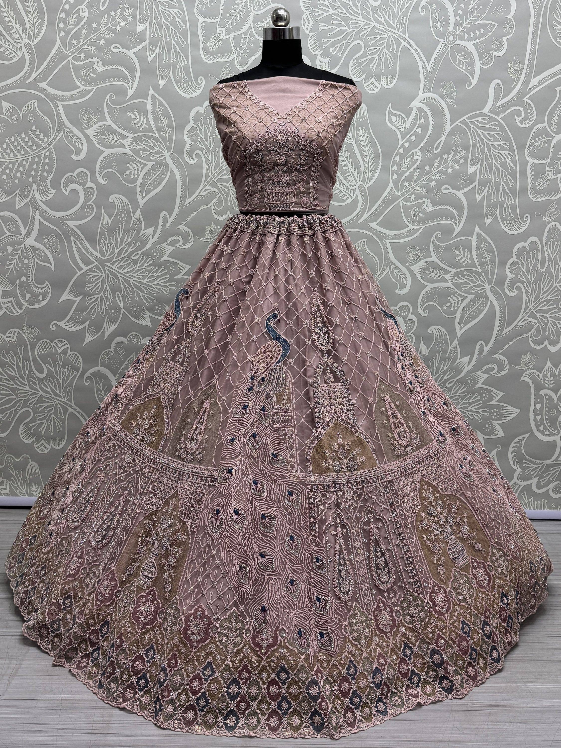 Elegant dusty pink lehenga choli with peacock embroidery and intricate net work, perfect for Indian weddings.