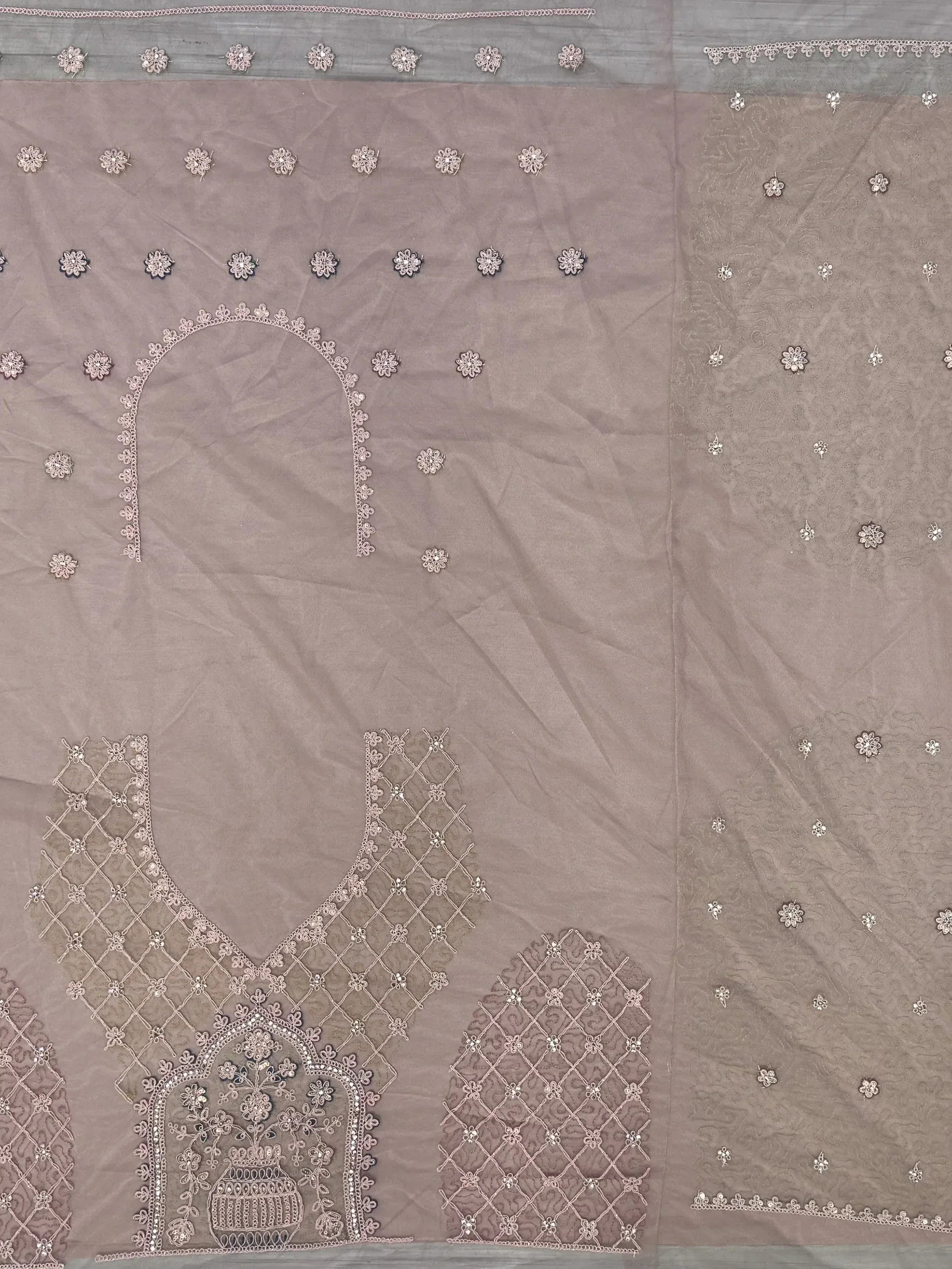 Elegant mauve salwar kameez with intricate floral embroidery and detailed neckline design