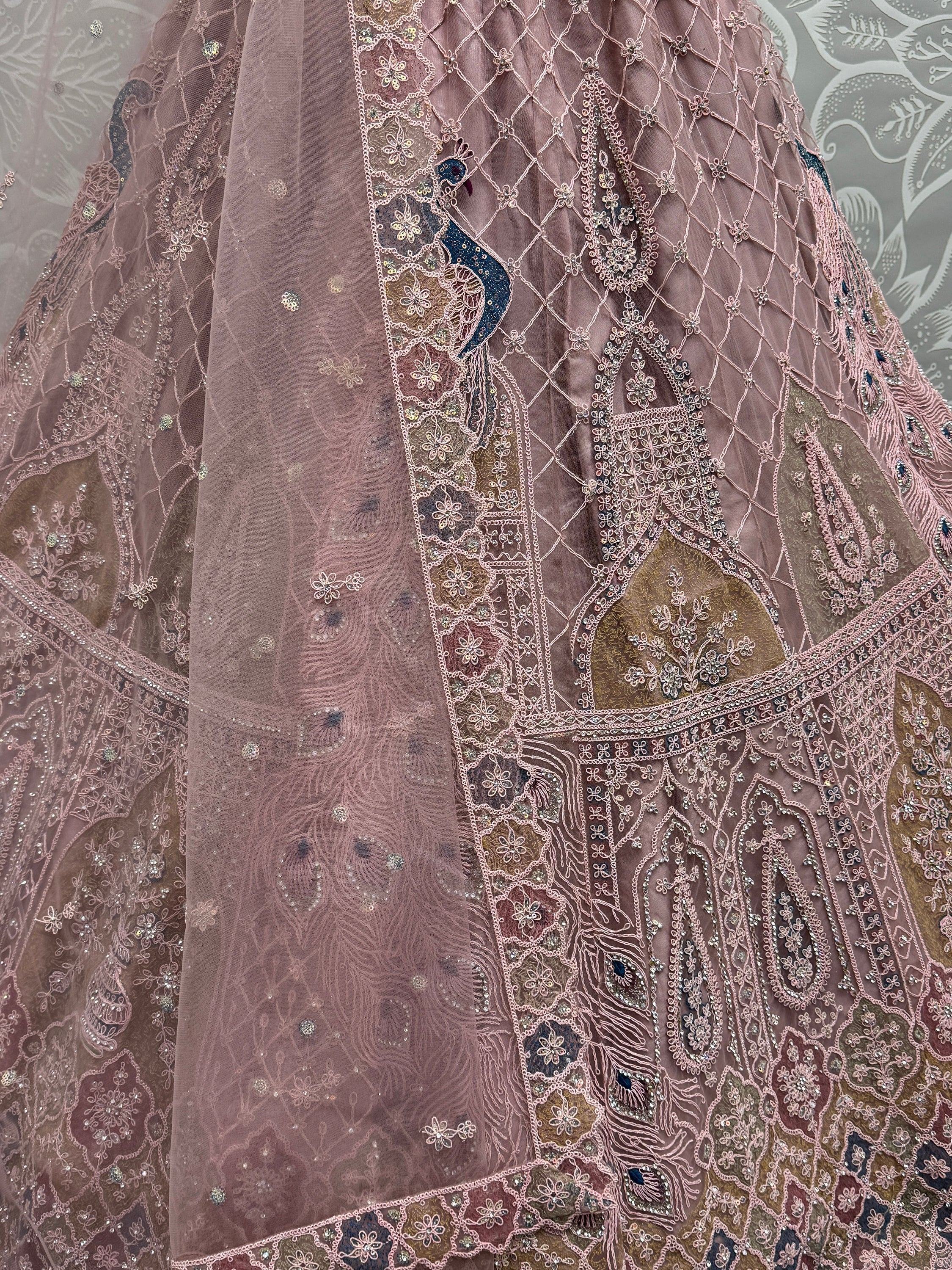 Dusty pink lehenga with intricate peacock embroidery and sequin detailing, perfect for Indian ethnic wear.