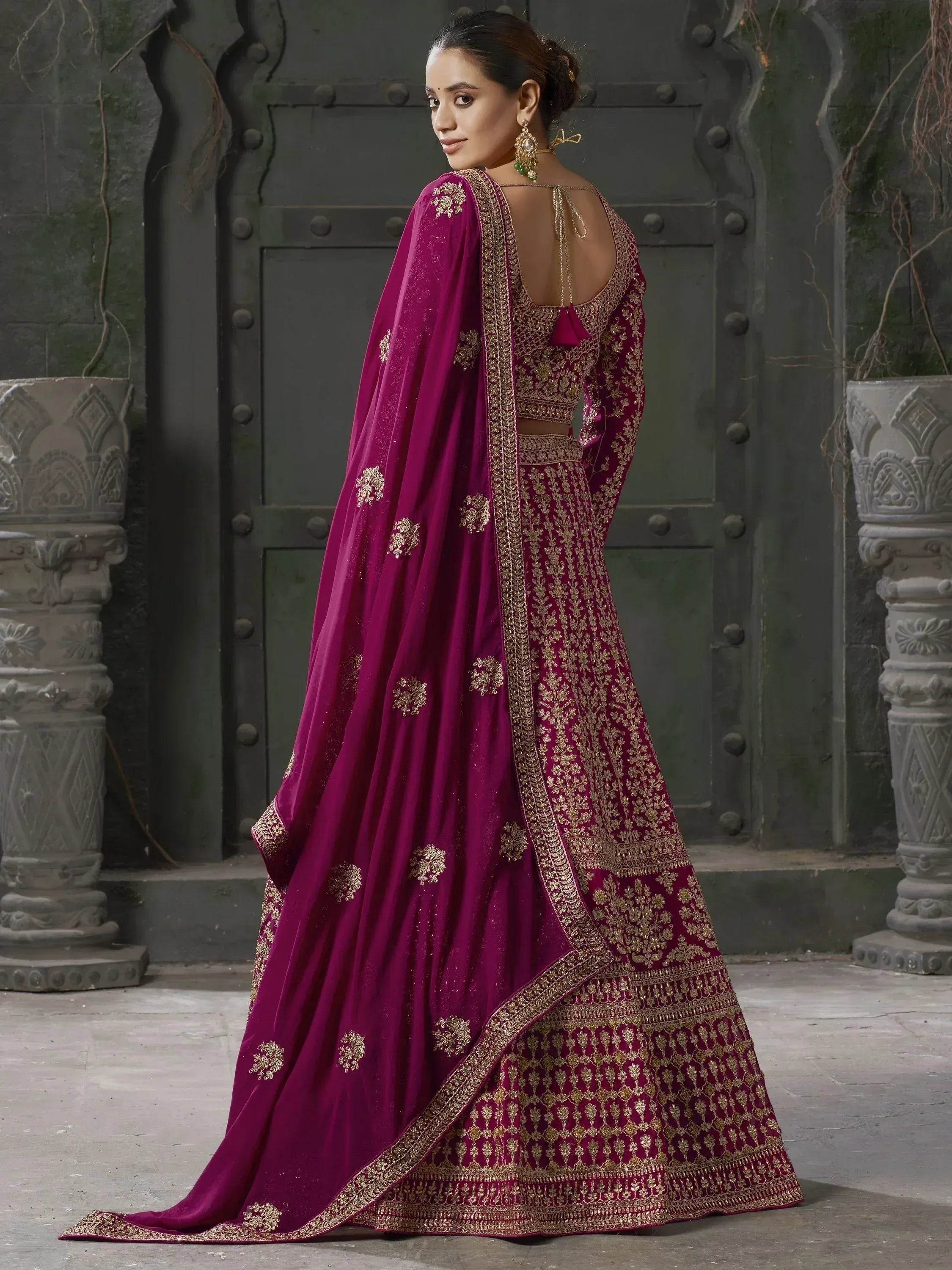 Elegant maroon lehenga choli with gold embroidery, perfect for Indian weddings and festive occasions.