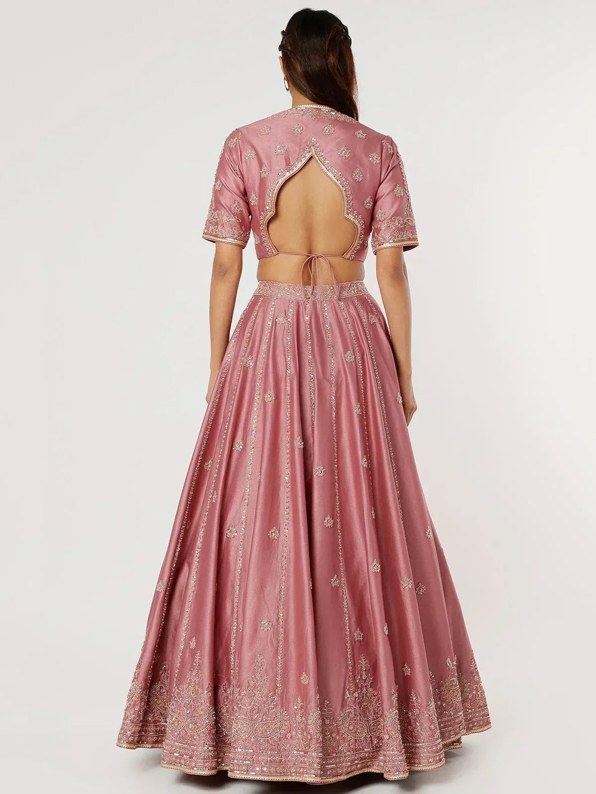 Pink embroidered lehenga choli with back cutout design, perfect for Indian ethnic wear occasions
