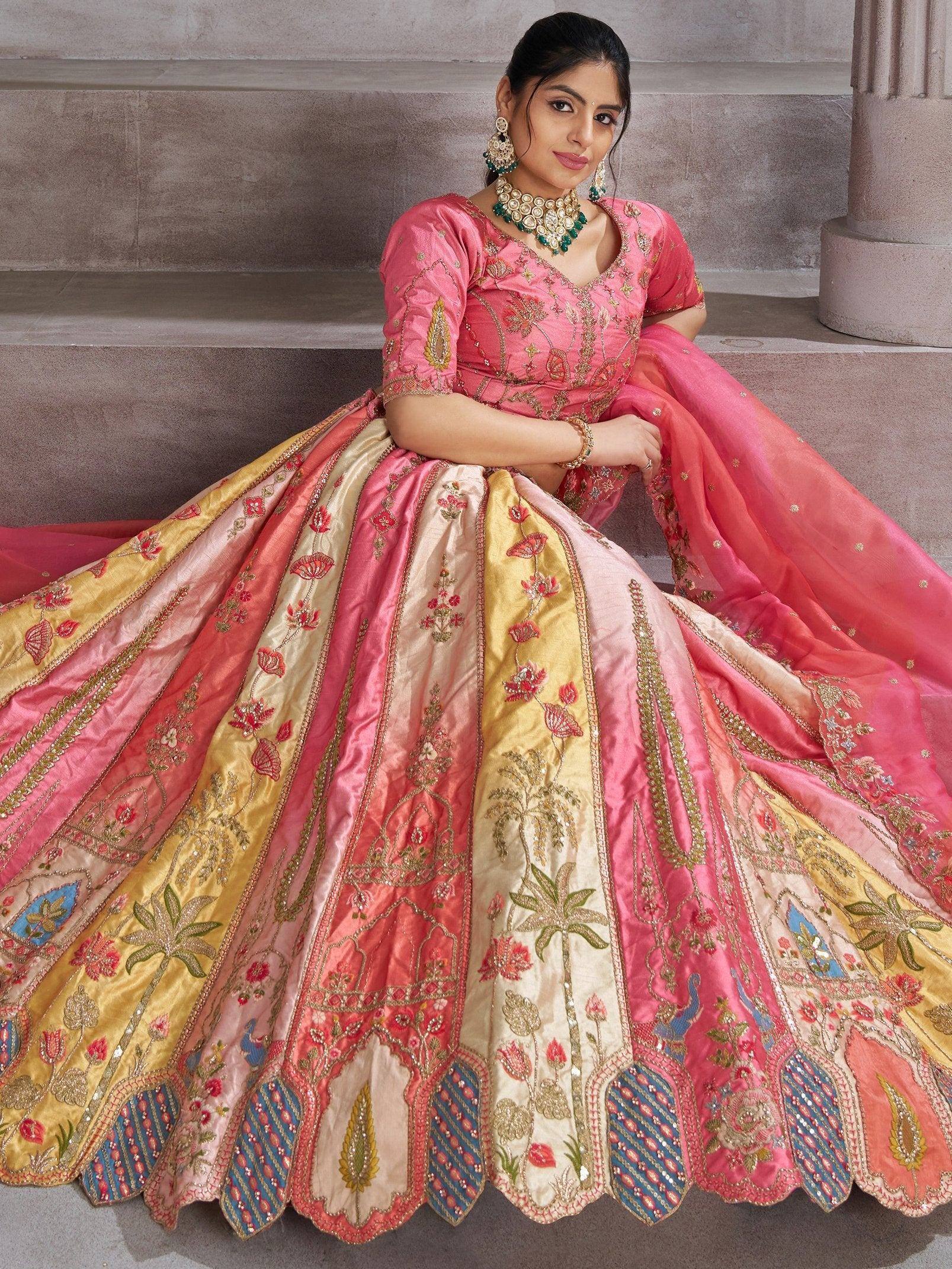 Pink and gold embroidered lehenga choli with floral motifs, perfect for Indian weddings and festive occasions.