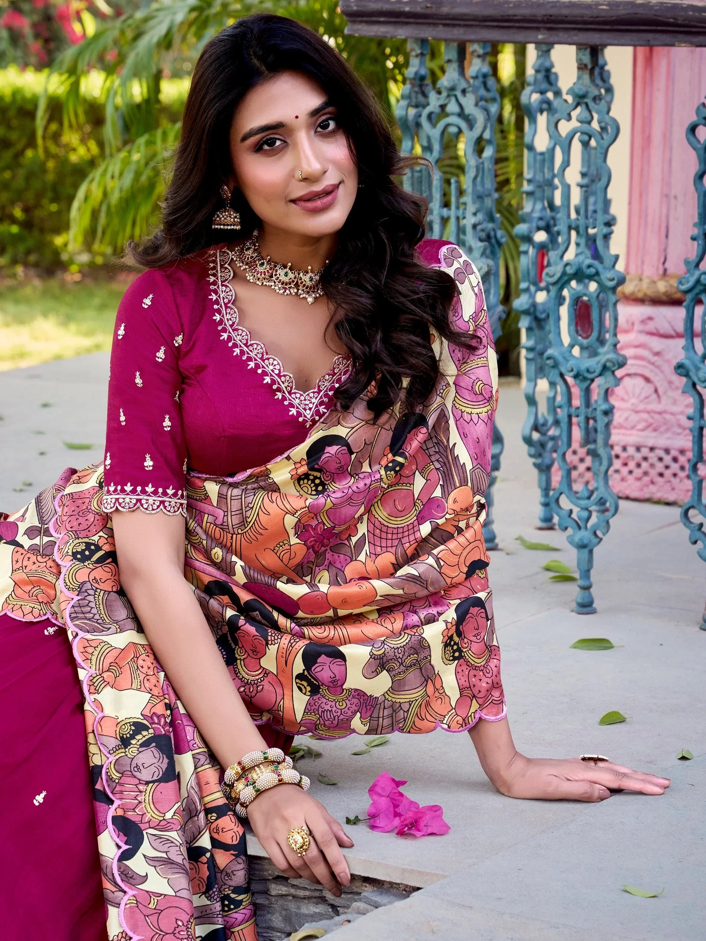 Woman in vibrant printed saree with embroidered magenta blouse, traditional Indian ethnic wear