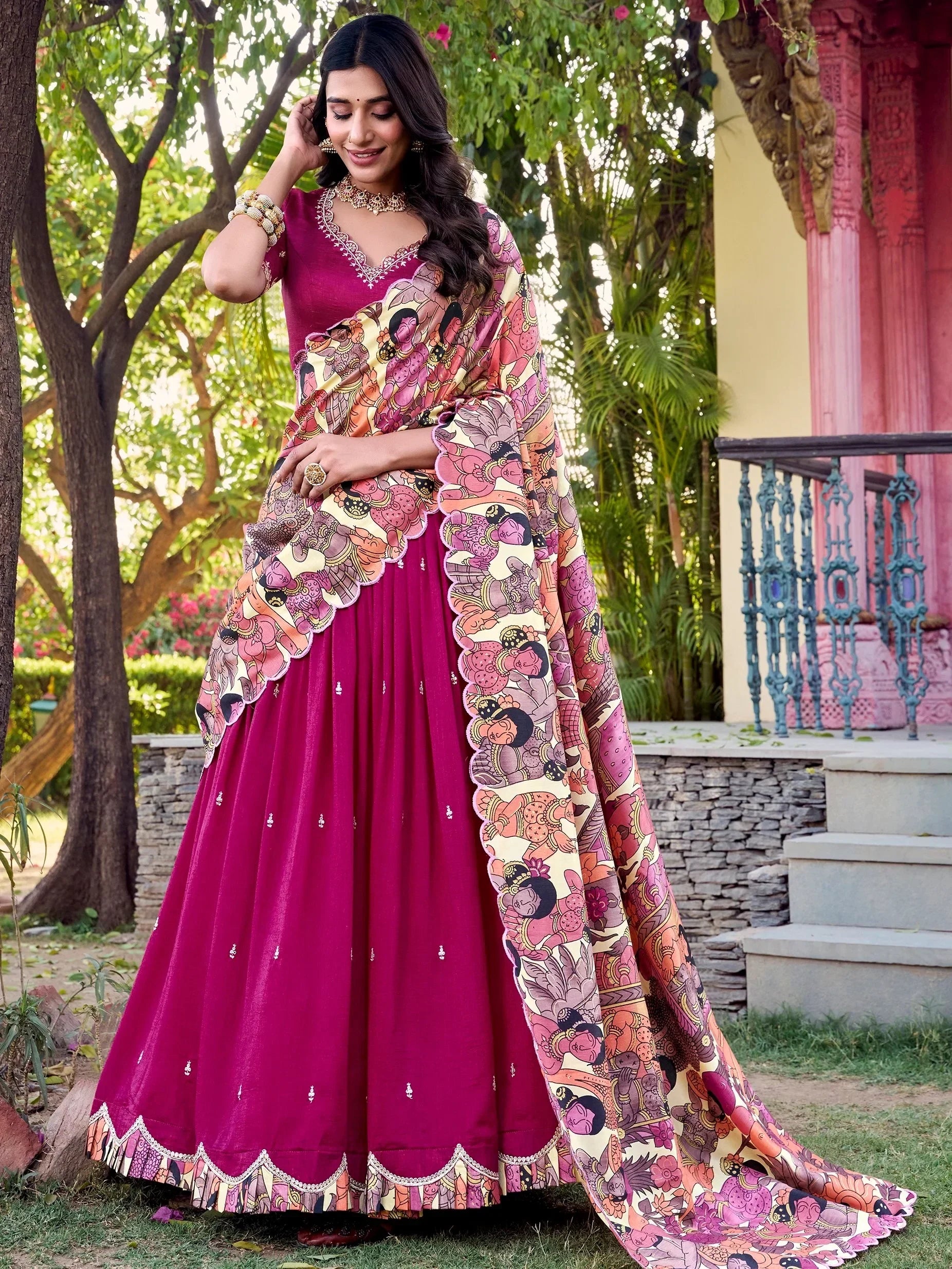 Woman in vibrant magenta designer lehenga choli with printed dupatta, perfect for Indian ethnic occasions