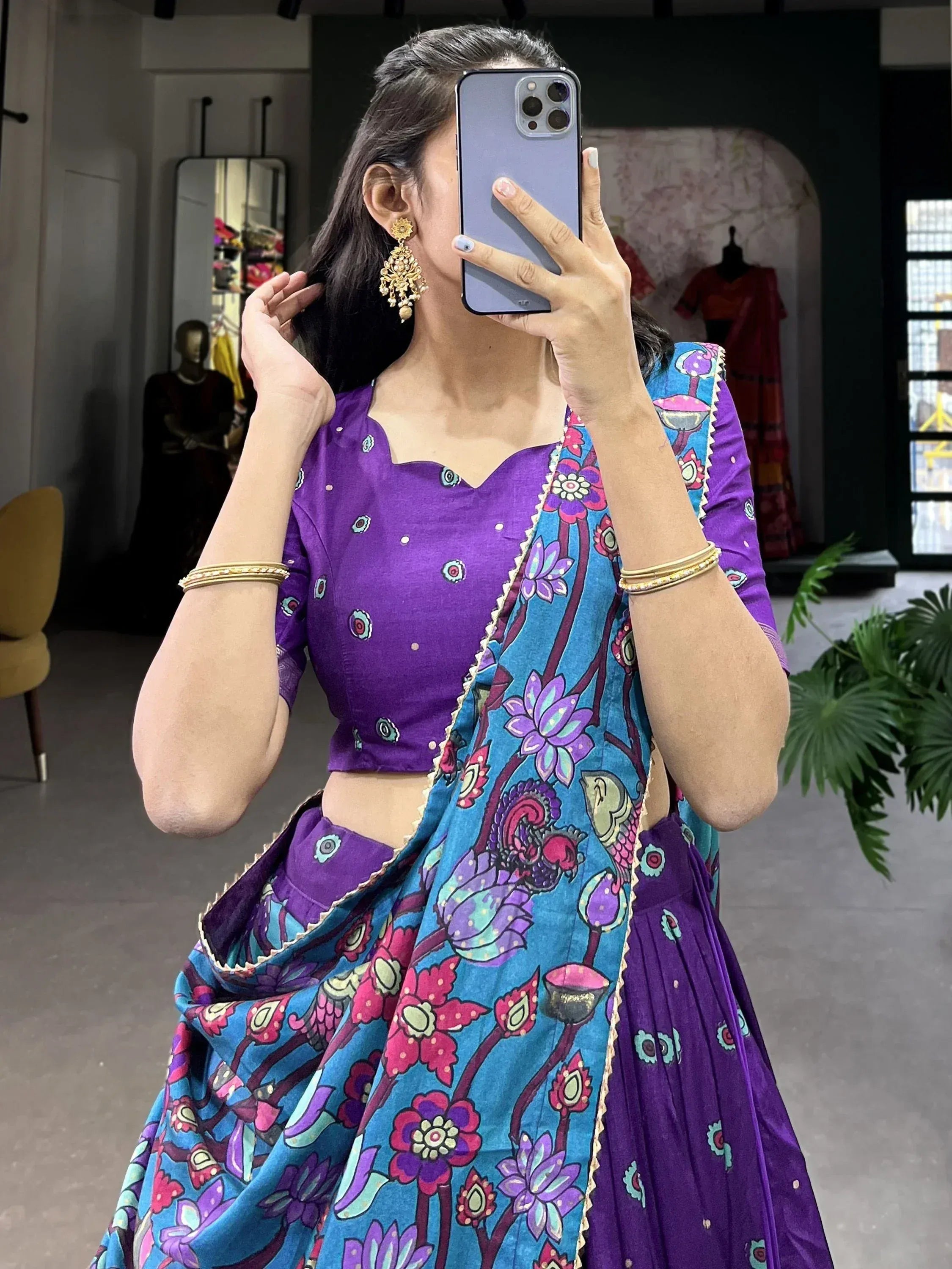 Woman in purple lehenga choli with blue floral dupatta, ethnic Indian wear