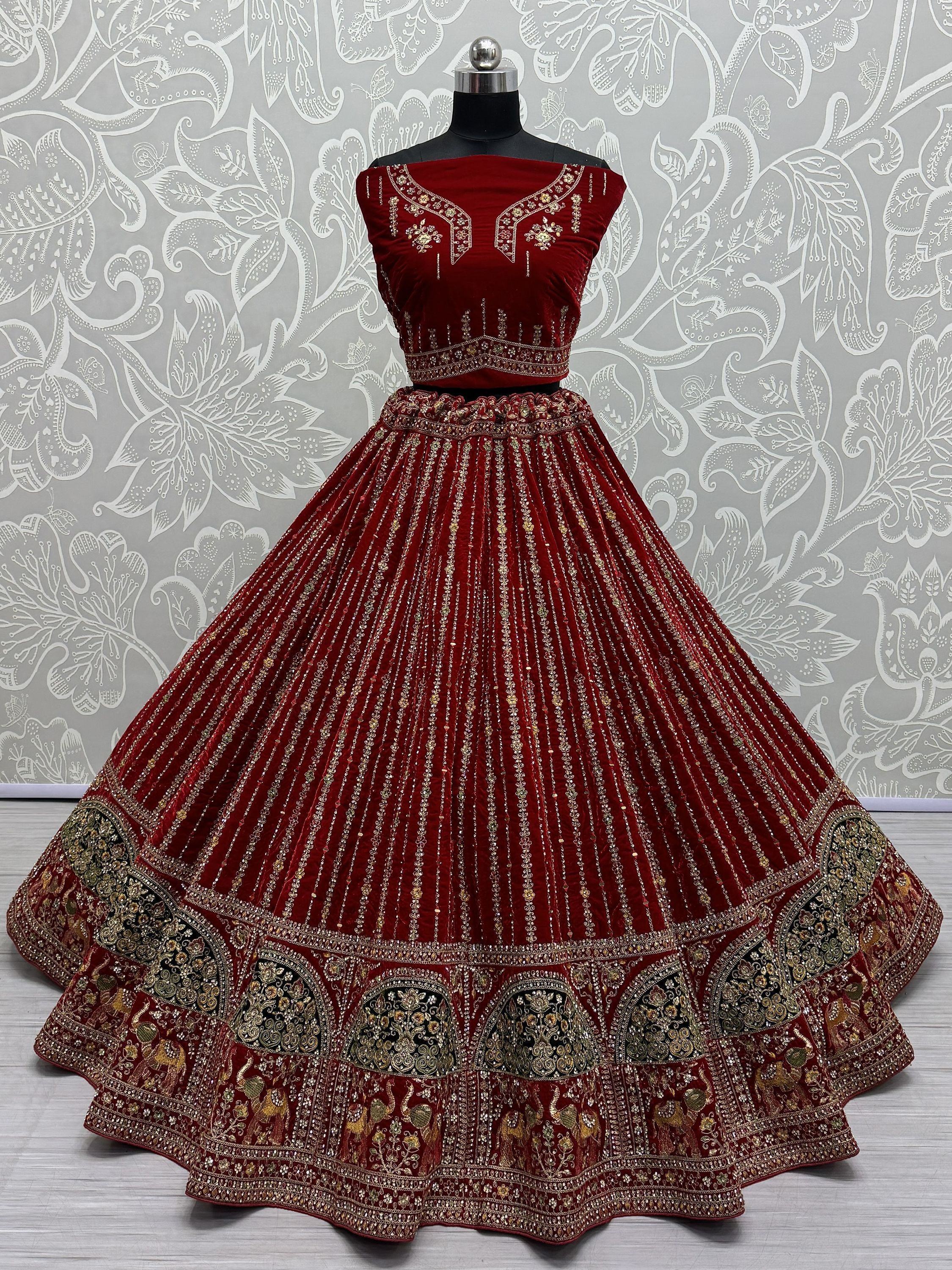 Maroon velvet lehenga choli with gold embroidery, perfect for Indian weddings and festive occasions.