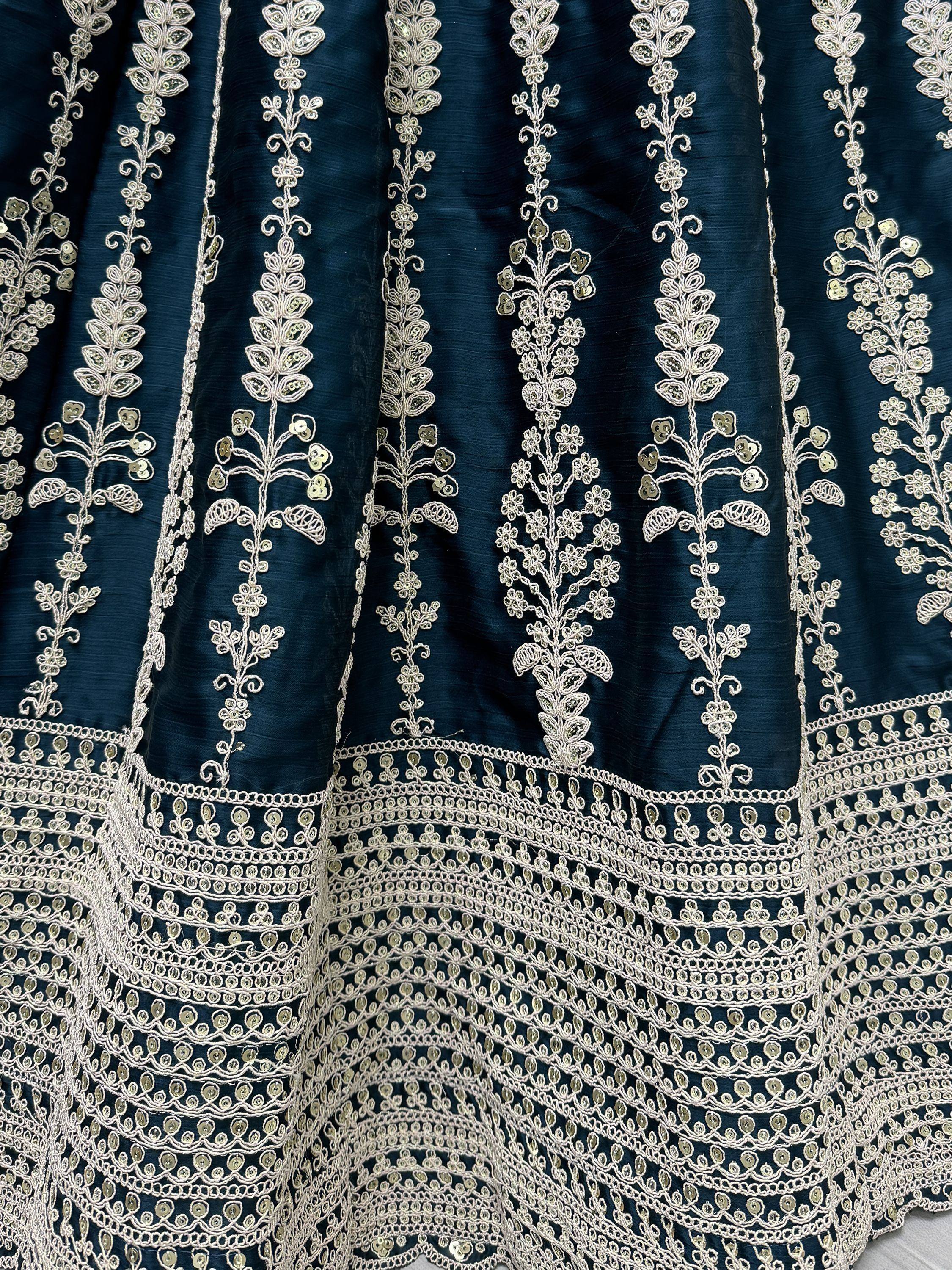 Dark blue ethnic gown with intricate white floral embroidery and sequin detailing, perfect for Indian occasions.