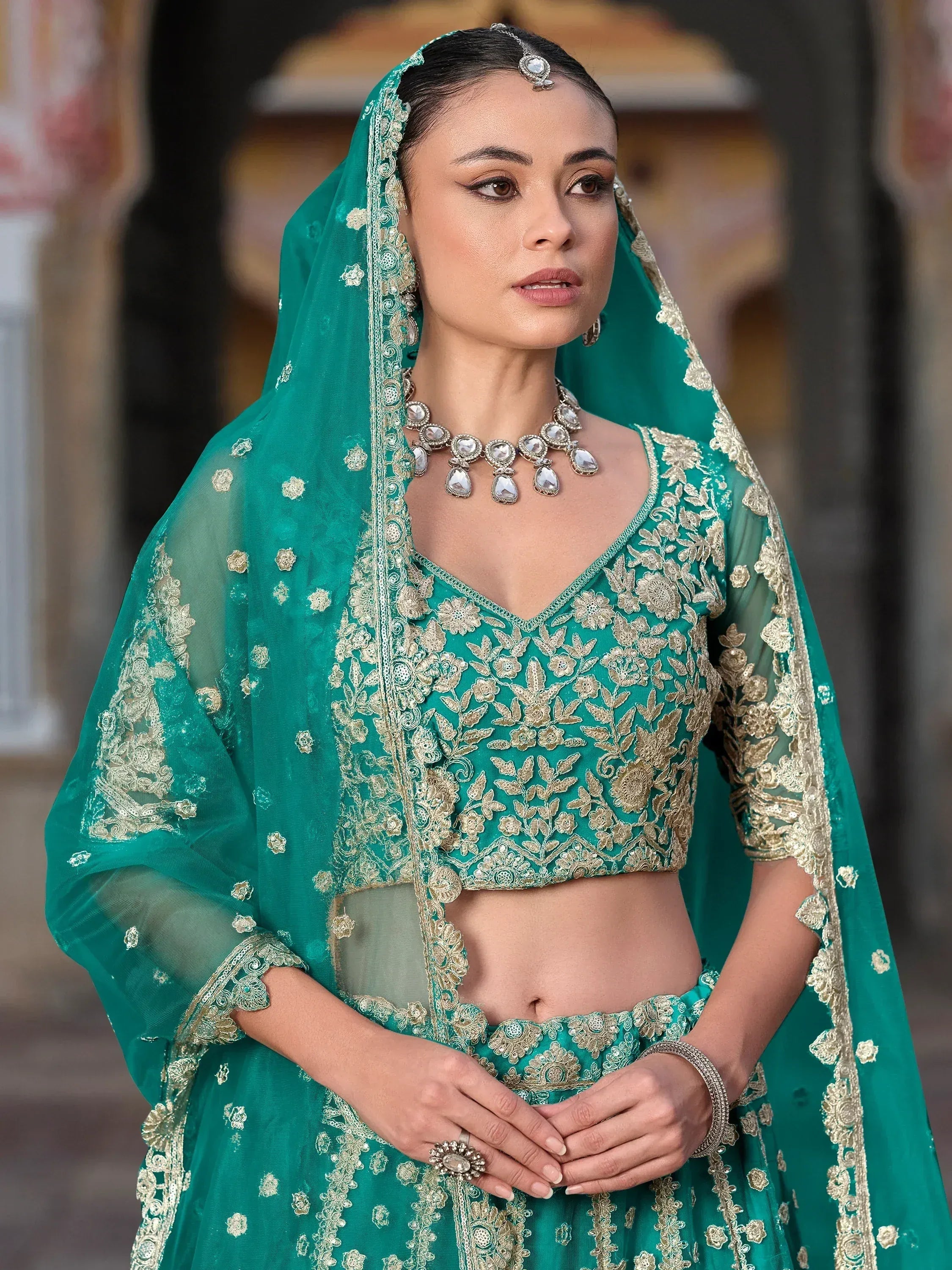 Emerald green designer lehenga choli with gold embroidery and matching dupatta for Indian weddings