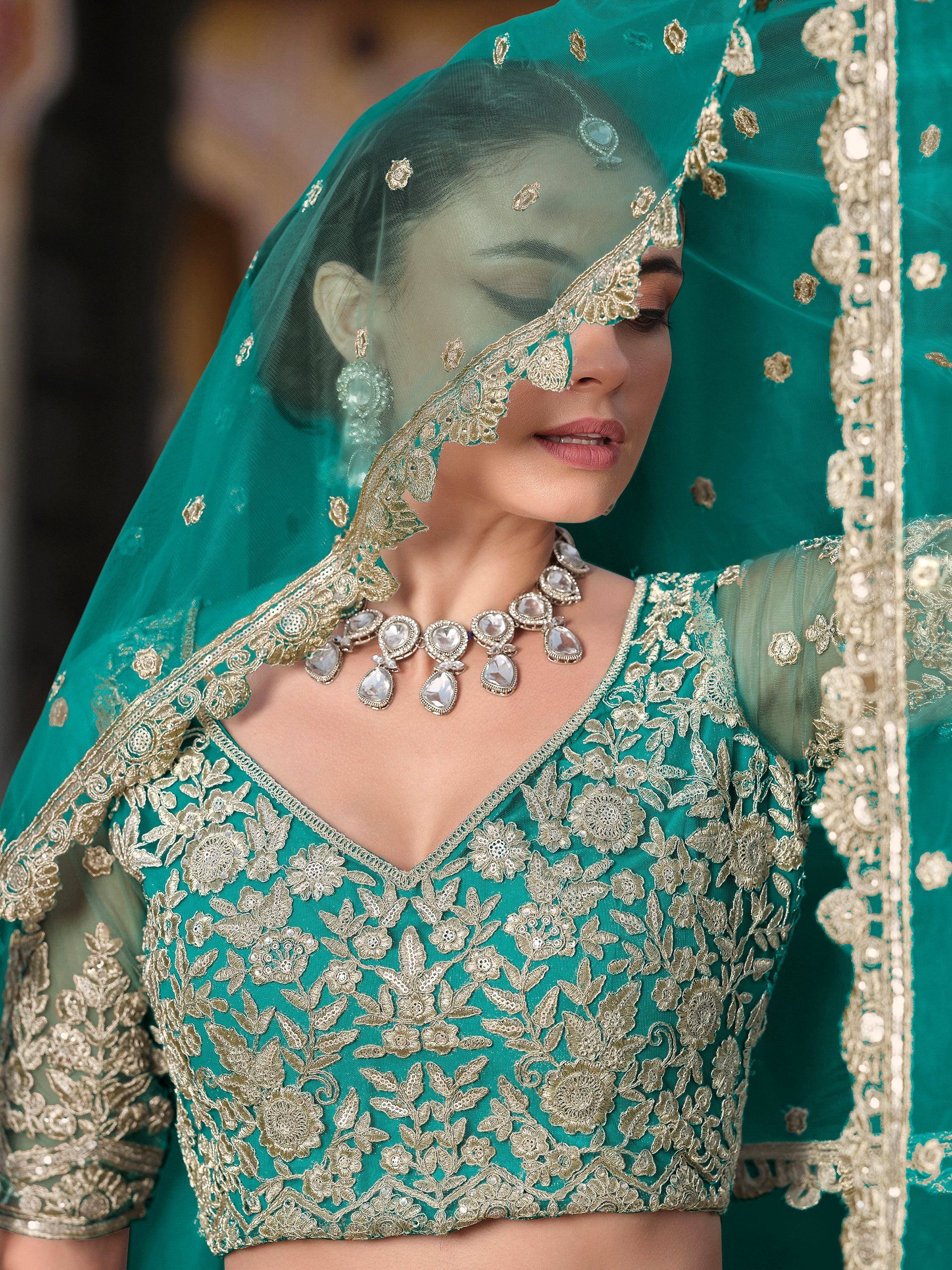 Teal green embroidered lehenga choli with gold floral work and matching dupatta for Indian weddings