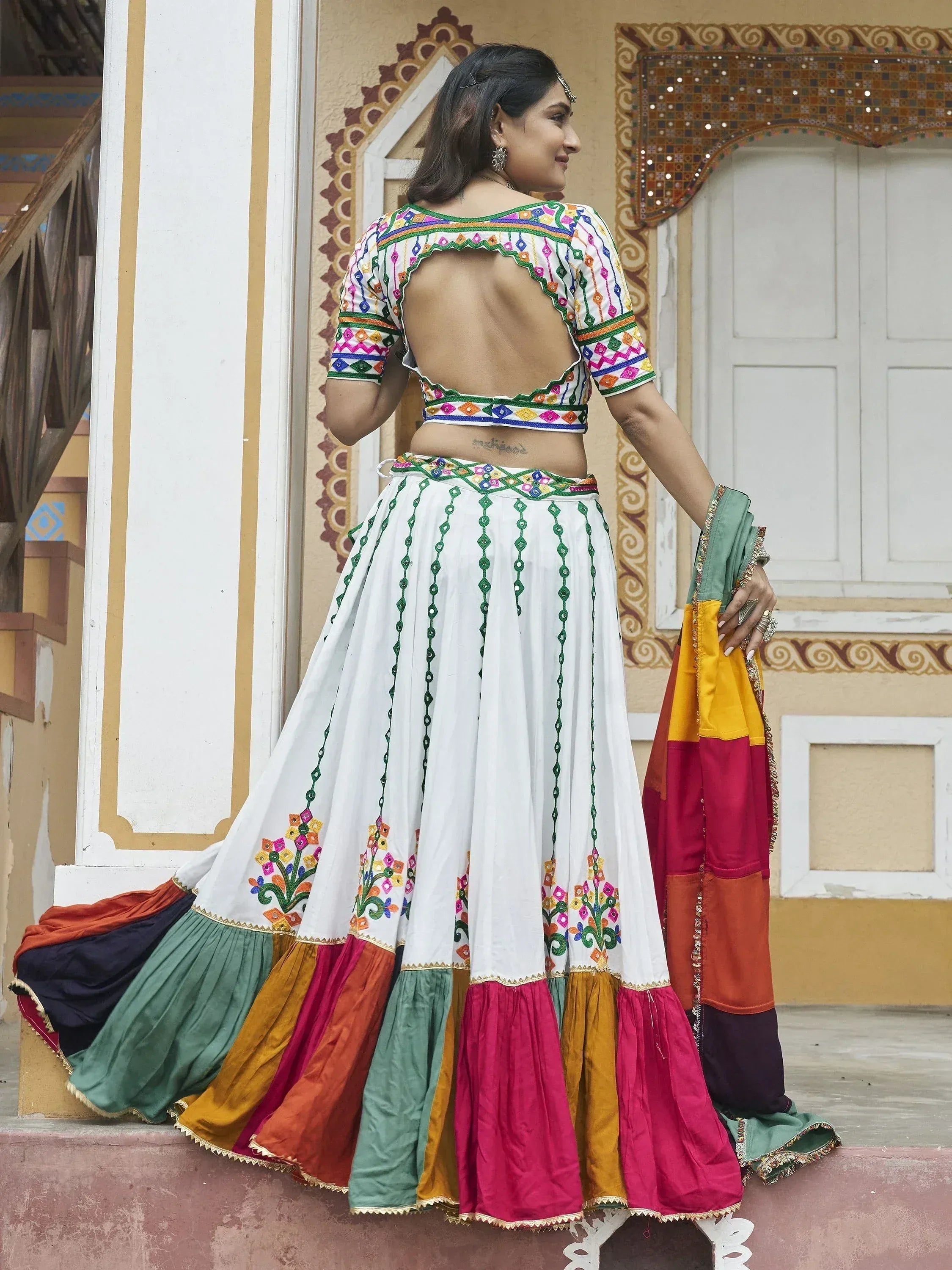 White embroidered lehenga choli with colorful skirt, backless blouse, and dupatta for Indian ethnic wear