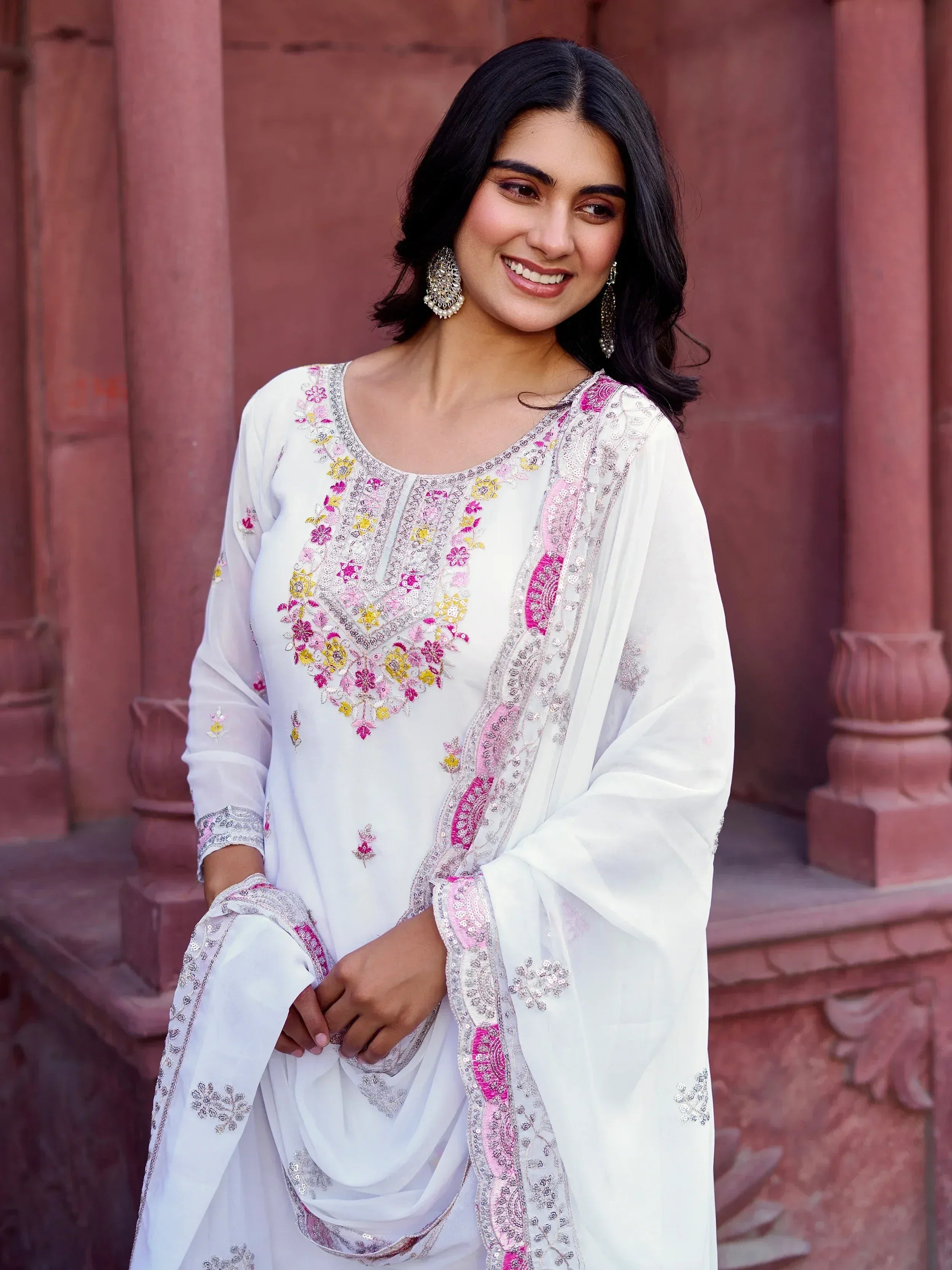 White embroidered salwar kameez with pink and yellow floral design, perfect for Indian ethnic wear