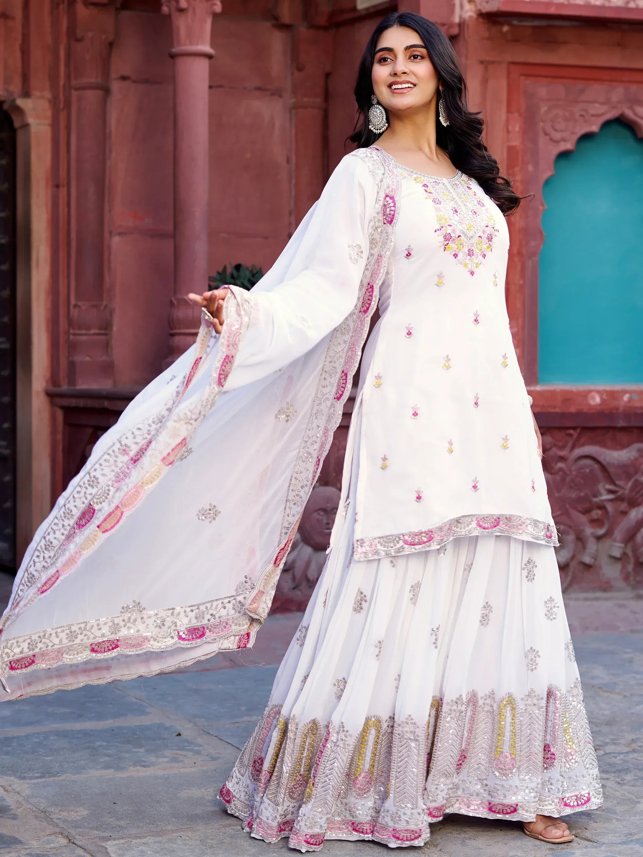 White embroidered ethnic sharara suit with pink and gold detailing, perfect for Indian festive occasions.