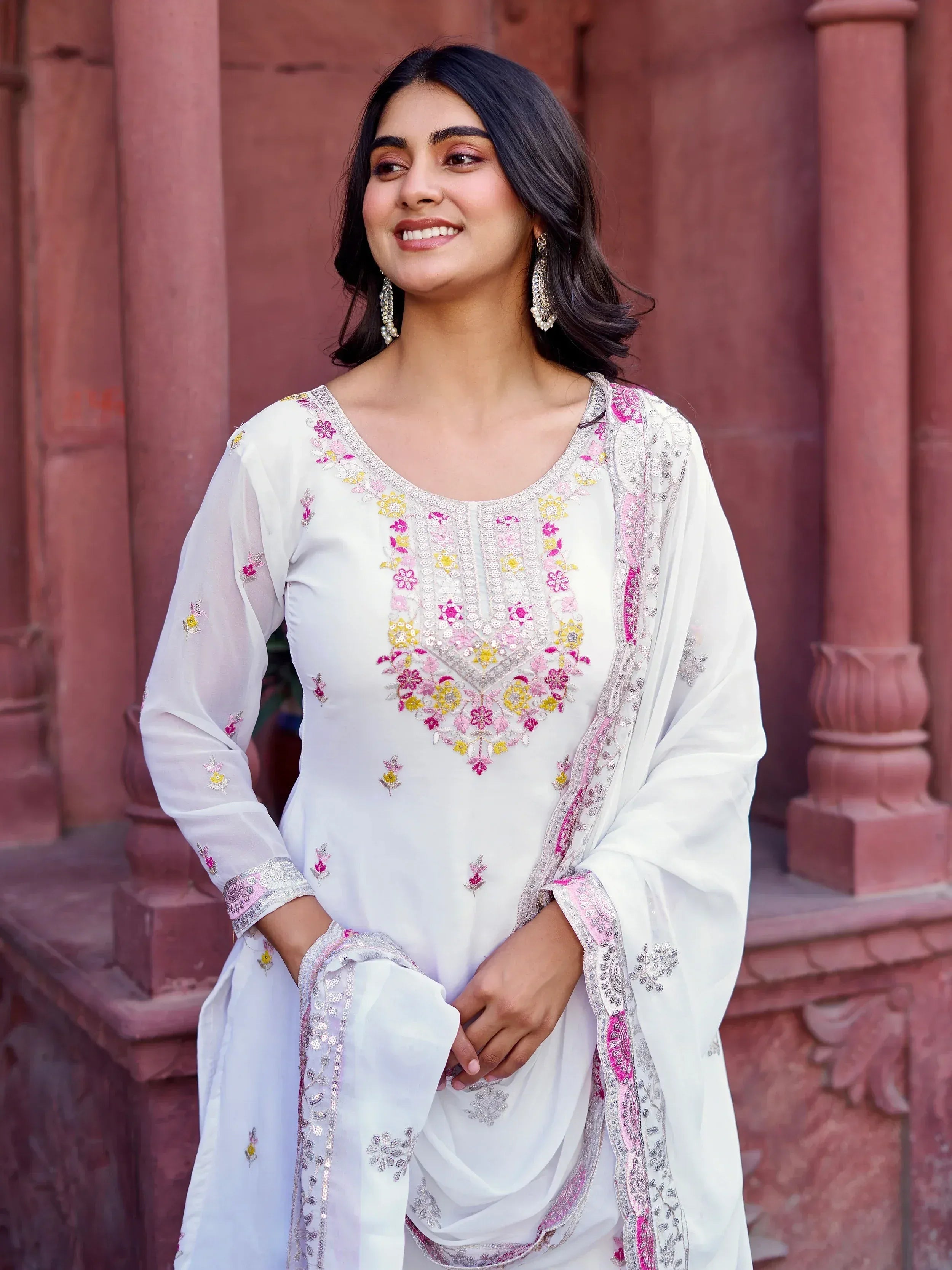 White embroidered salwar kameez with pink and yellow floral details, perfect for Indian ethnic wear