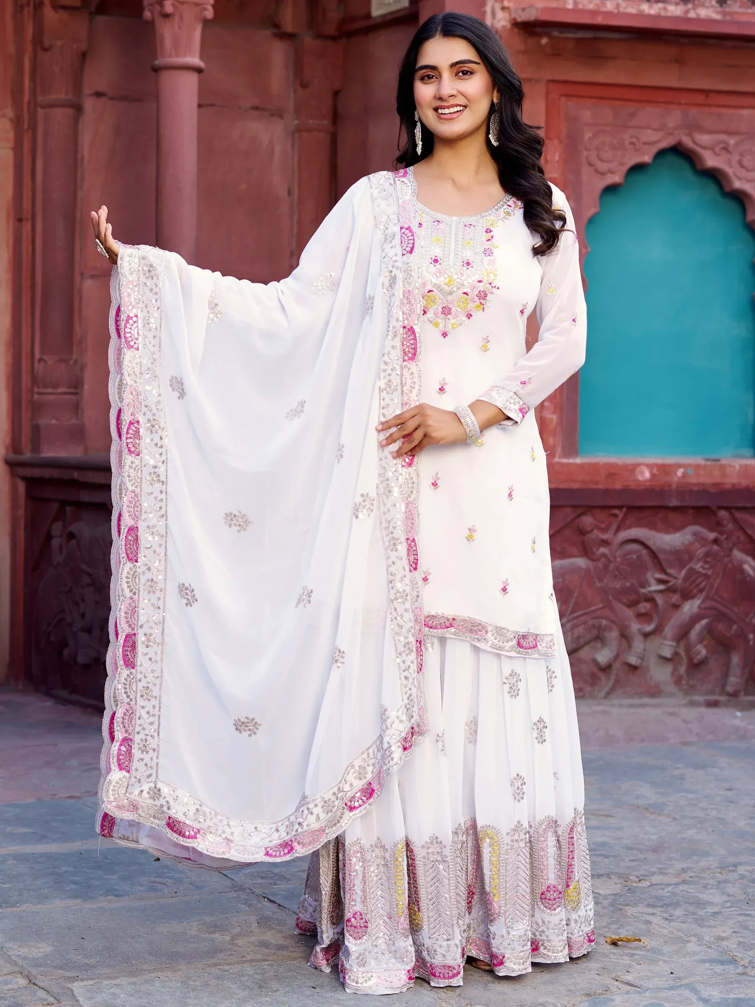 White embroidered salwar kameez with pink and gold detailing, perfect for ethnic occasions
