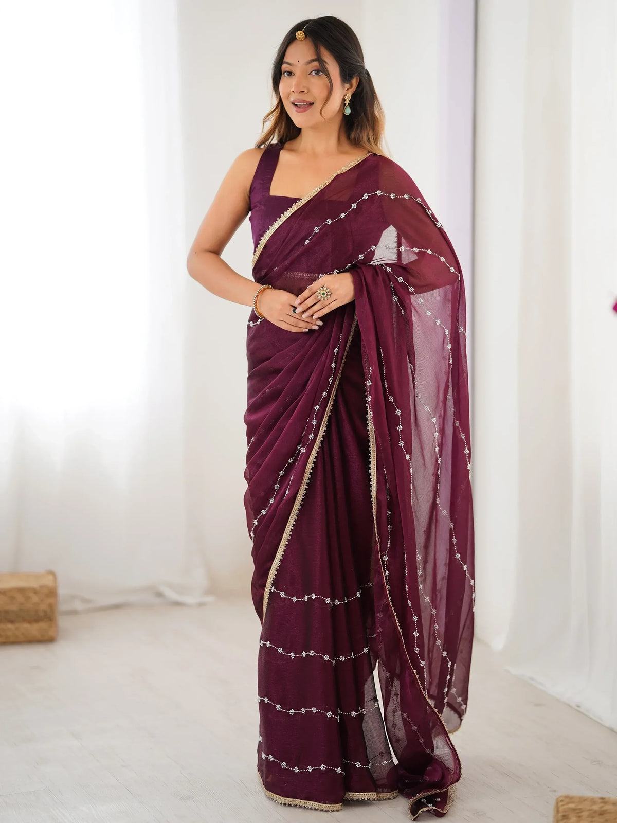 Elegant maroon saree with gold trim and floral embroidery, perfect for Indian ethnic occasions