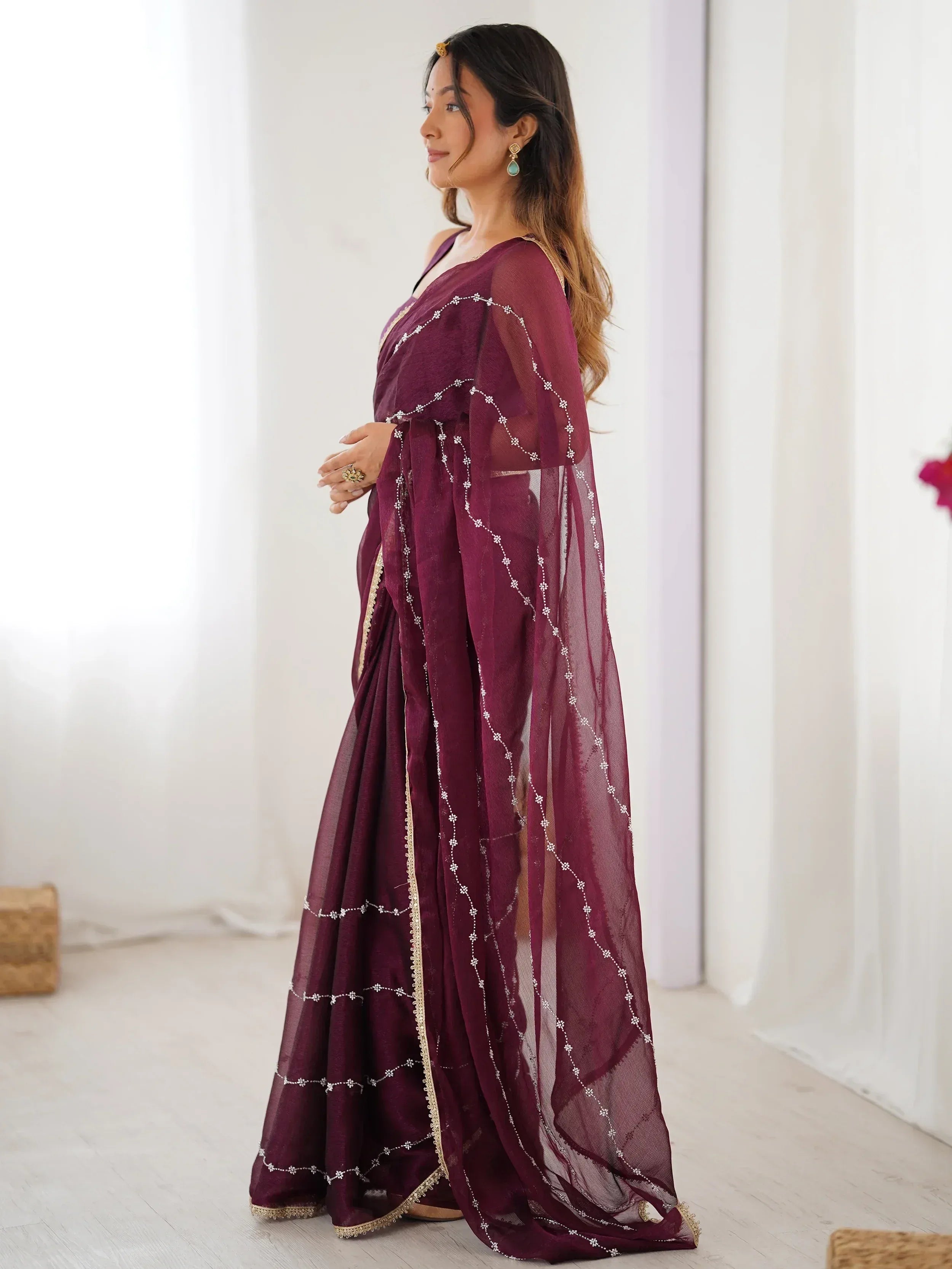Elegant maroon saree with floral embroidery and gold border, perfect for Indian ethnic occasions