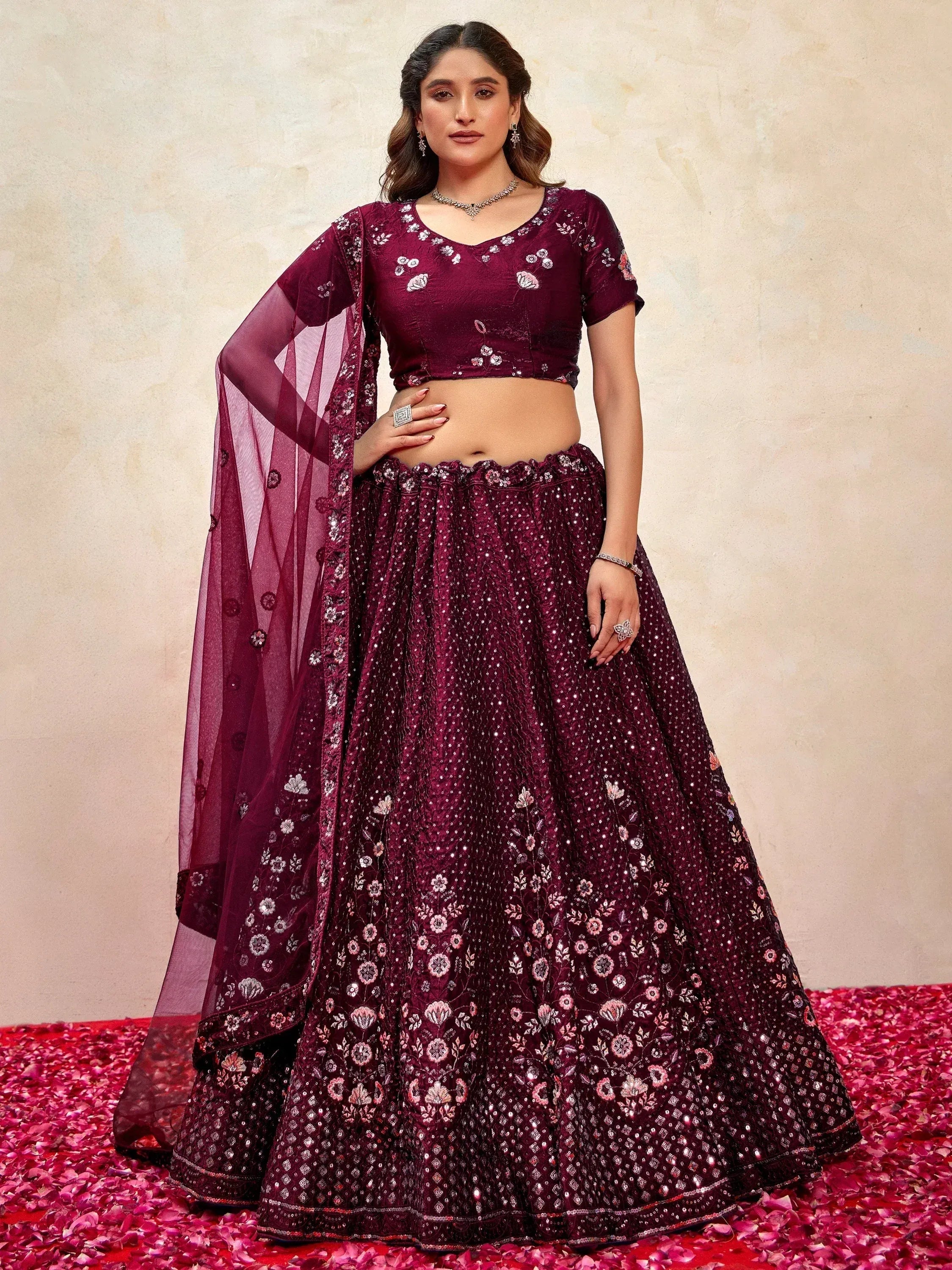 Burgundy designer lehenga choli with floral embroidery and sequins, perfect for Indian weddings and festive occasions.