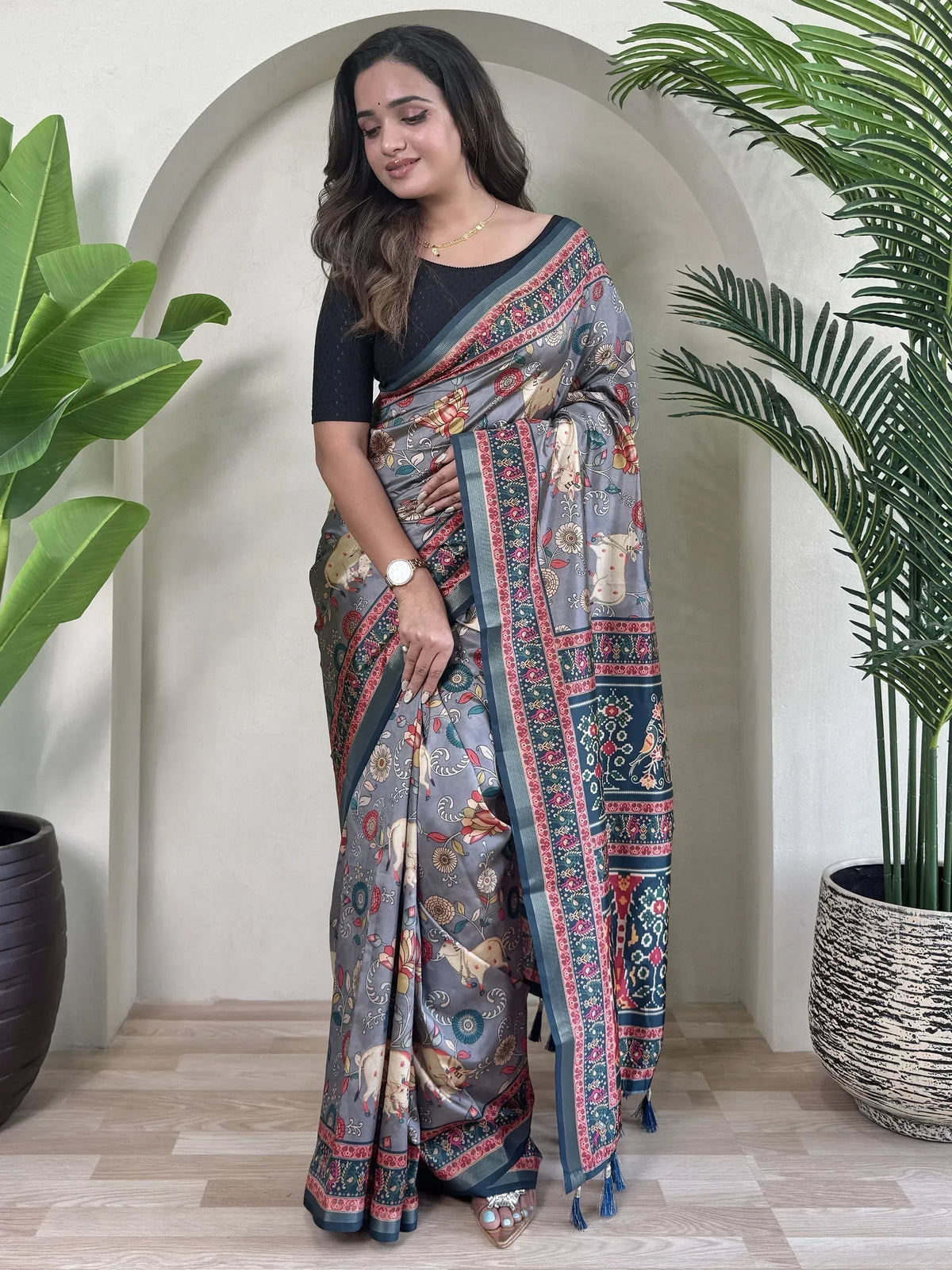 Grey floral and elephant print saree with blue border, paired with black blouse, ideal for ethnic occasions