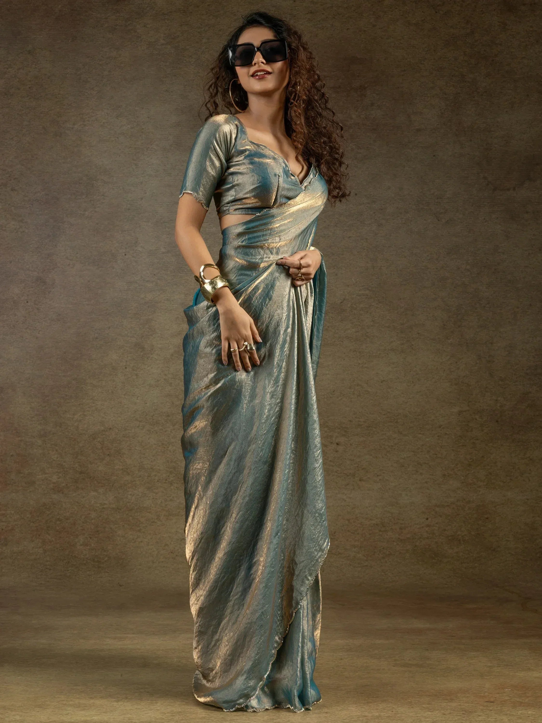 Stylish teal and gold metallic saree with matching blouse, perfect for Indian ethnic occasions