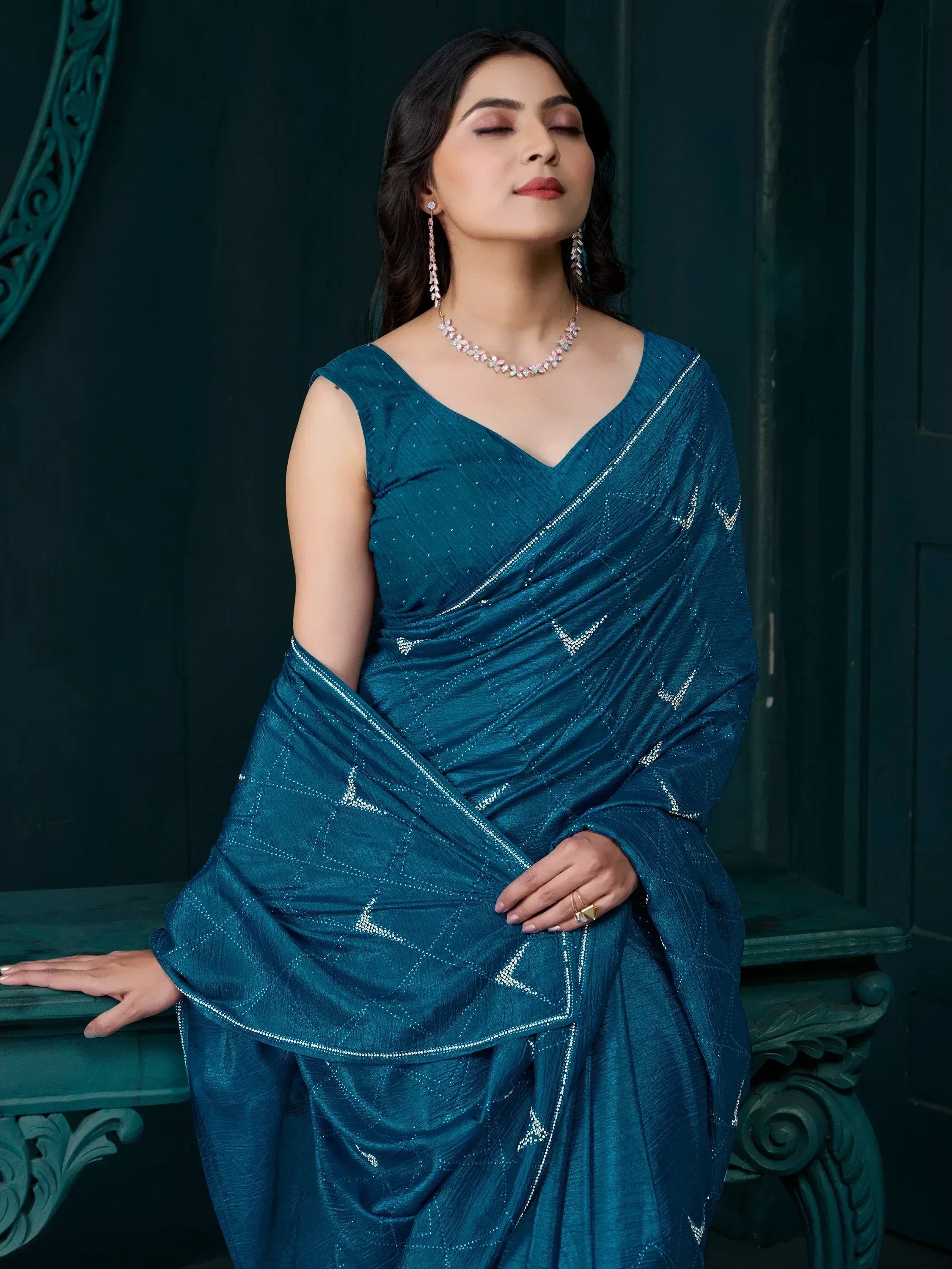 Elegant teal saree with silver embroidery, perfect for Indian ethnic wear occasions.