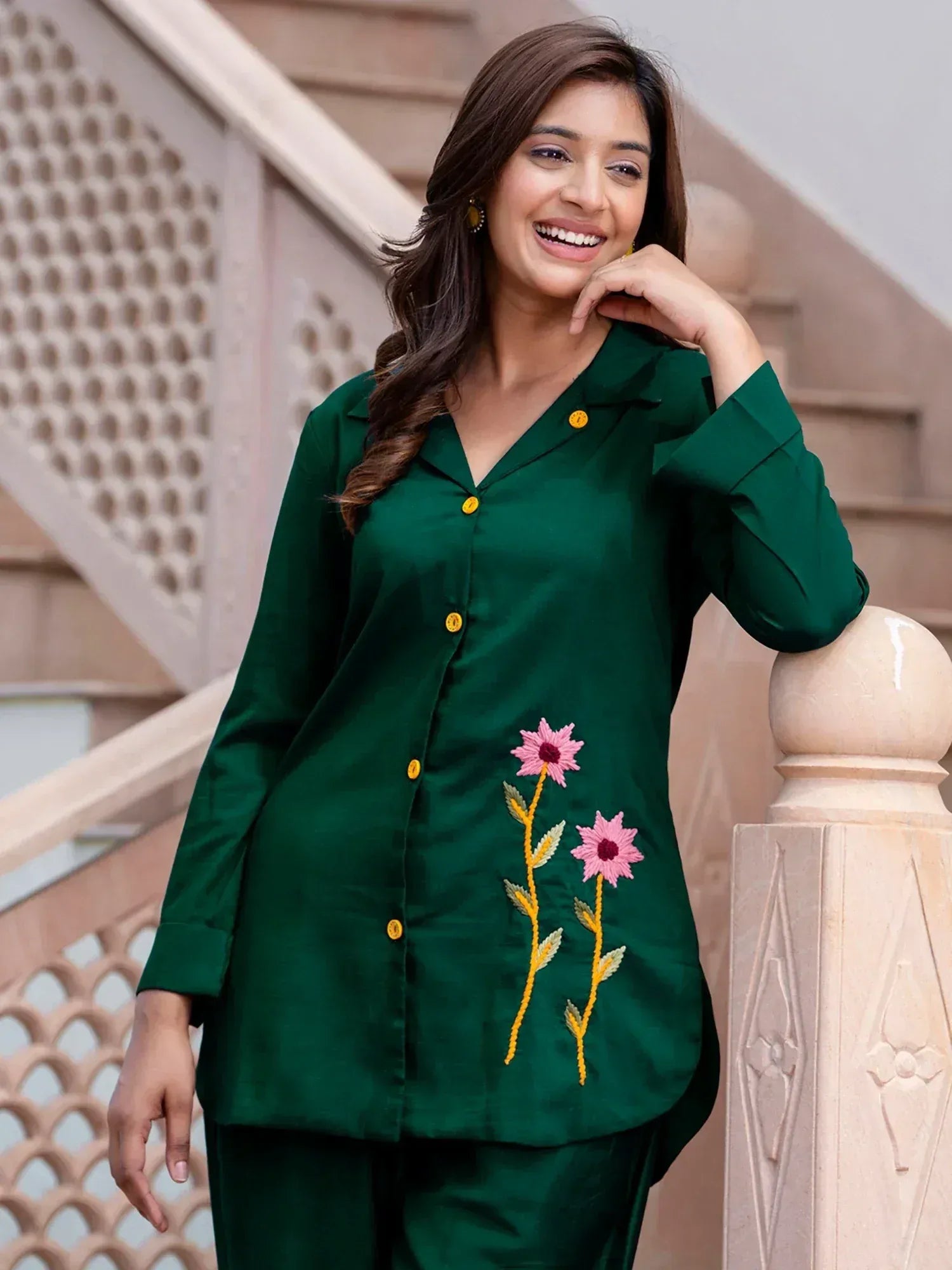 Emerald green ethnic kurta with pink floral embroidery, yellow buttons, and matching pants for women