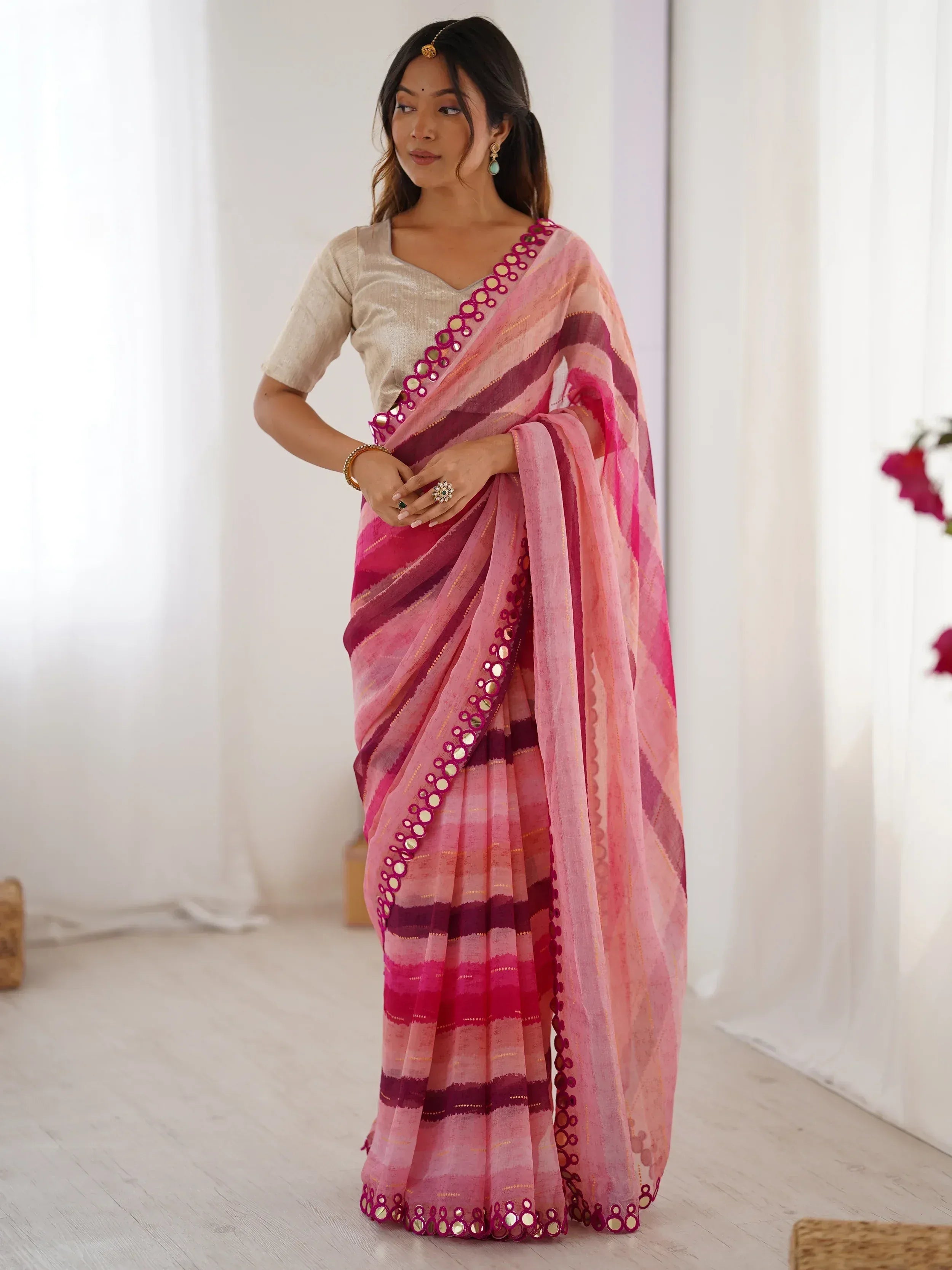 Pink and maroon striped saree with mirror work border, paired with beige blouse, ethnic Indian wear
