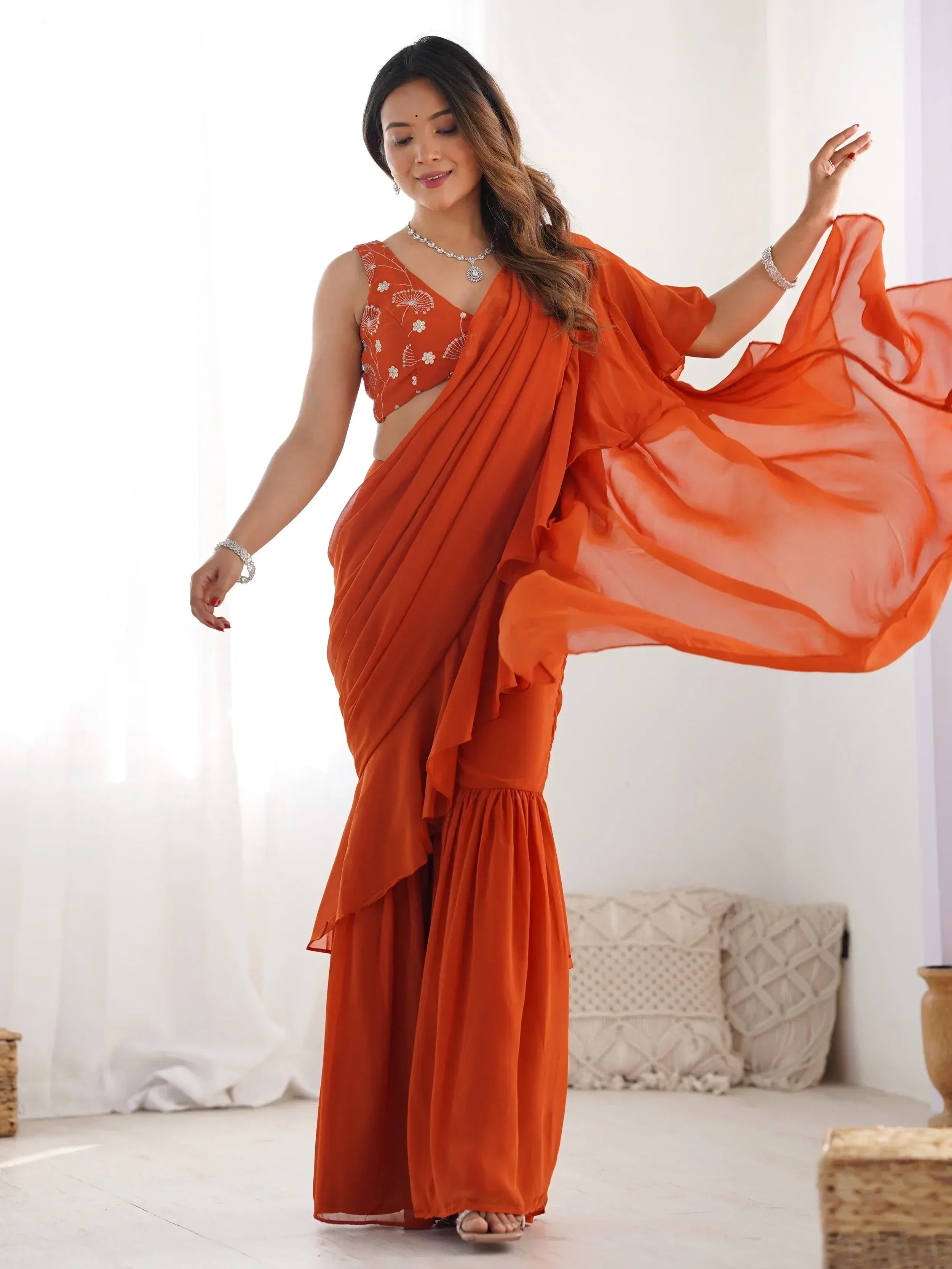 Orange saree with floral embroidered blouse, flowing drape, and palazzo pants for Indian ethnic wear